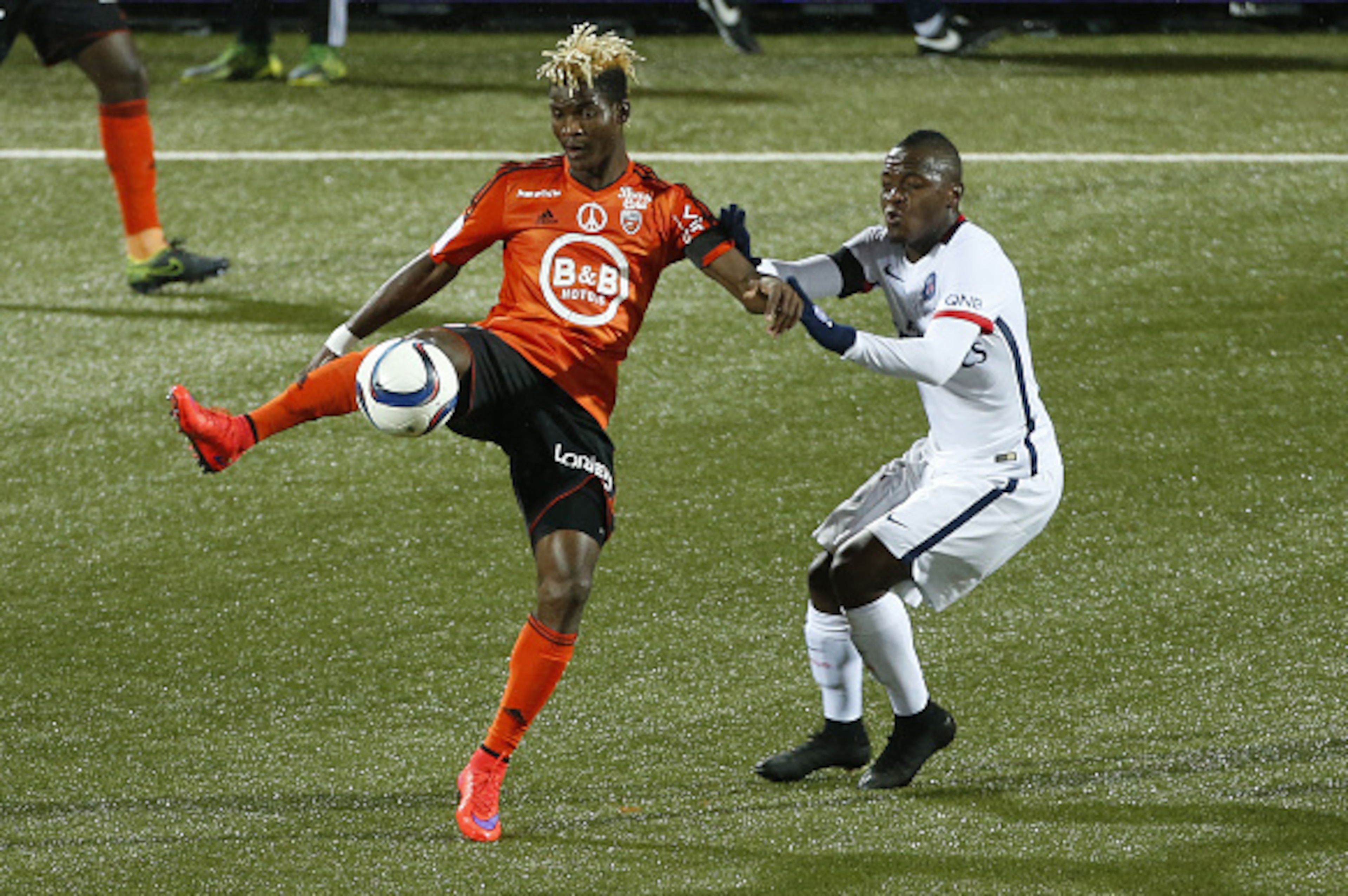 LORIENT, FRANCE - NOVEMBER 21: Didier Ibrahim Ndong of FC Lorient and Hervin Ongenda of PSG in action during the French Ligue 1 match between FC Lorient and Paris Saint-Germain (PSG) at Stade du Moustoir on November 21, 2015 in Lorient, France. (Photo by LORIENT, FRANCE - NOVEMBER 21: Didier Ibrahim Ndong of FC Lorient and Hervin Ongenda of PSG in action during the French Ligue 1 match between FC Lorient and Paris Saint-Germain (PSG) at Stade du Moustoir on November 21, 2015 in Lorient, France. (Photo by