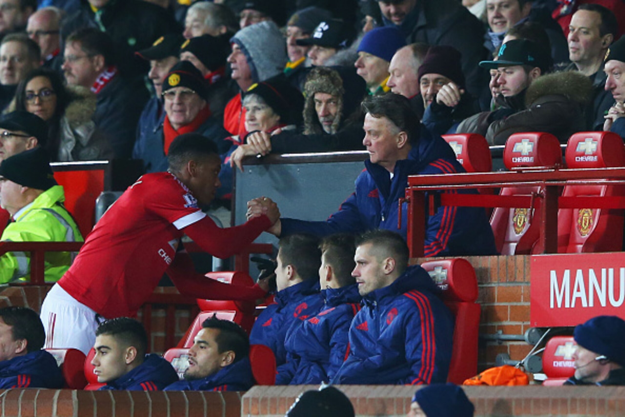 MANCHESTER, ENGLAND - FEBRUARY 02: Louis van Gaal Manager of Manchester United shakes hands with Anthony Martial on the bench during the Barclays Premier League match between Manchester United and Stoke City at Old Trafford on February 2, 2016 in Manchest