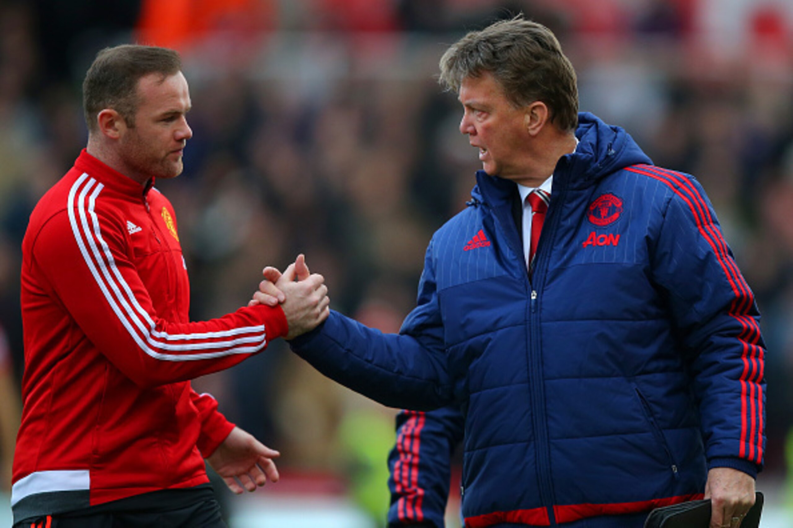 STOKE ON TRENT, ENGLAND - DECEMBER 26:  Louis van Gaal, manager of Manchester United shakes hands with Wayne Rooney of Manchester United during the Barclays Premier League match between Stoke City and Manchester United at Britannia Stadium on December 26,