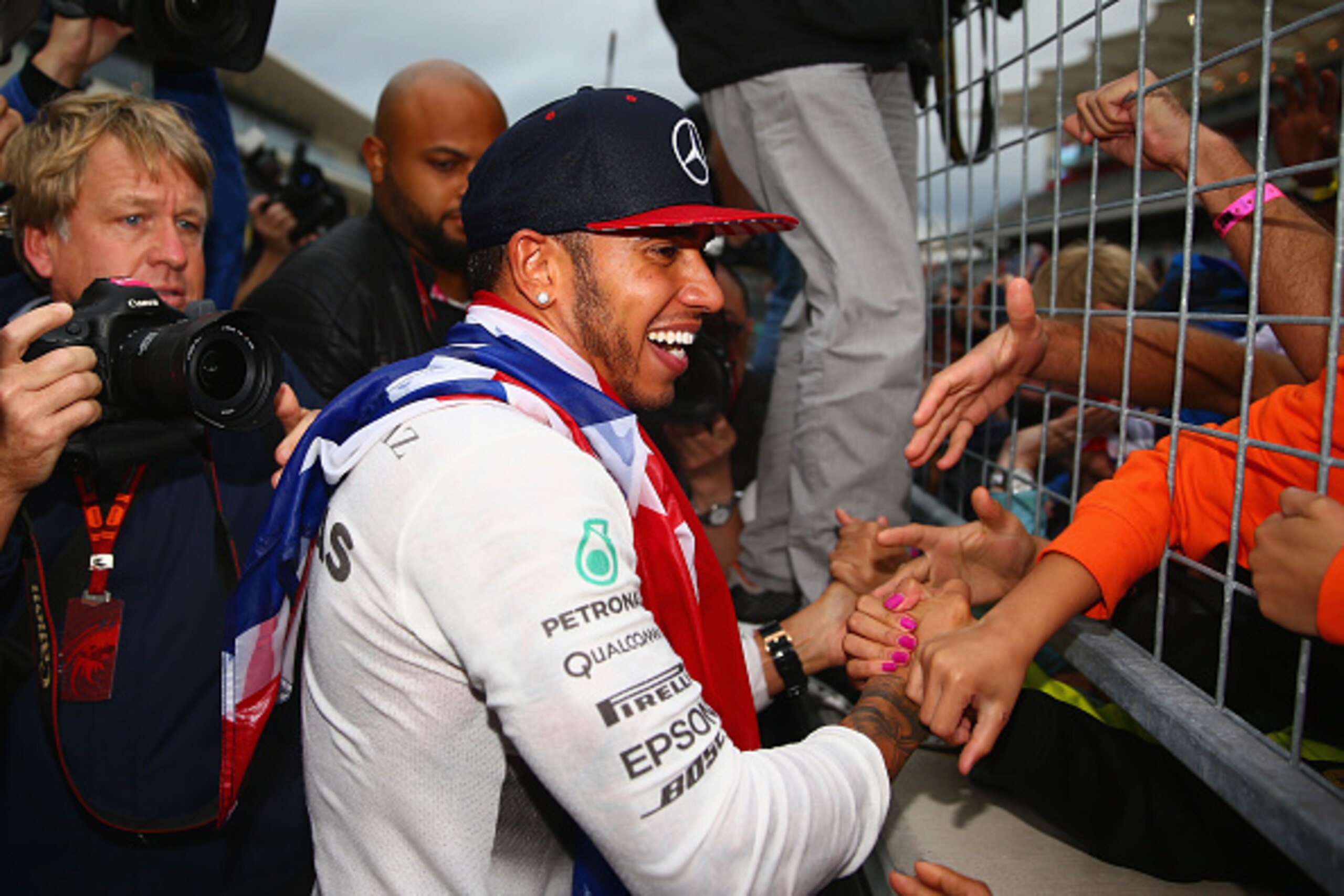 AUSTIN, TX - OCTOBER 25:  Lewis Hamilton of Great Britain and Mercedes GP celebrates with fans waiting along the pit straight after winning the United States Formula One Grand Prix and the championship at Circuit of The Americas on October 25, 2015 in Aus