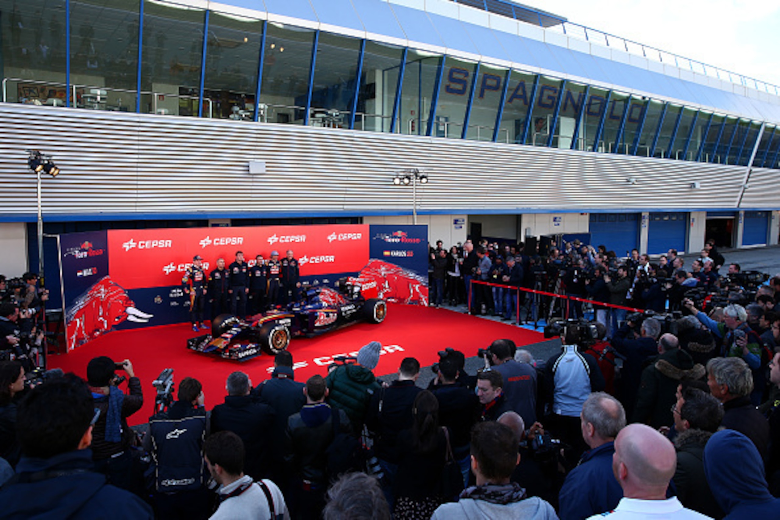 JEREZ DE LA FRONTERA, SPAIN - JANUARY 31:  Max Verstappen (L) of Netherlands and Scuderia Toro Rosso and Carlos Sainz Jr (R) of Spain and Scuderia Toro Rosso pose with designer Paolo Marabini (2nd L), technical director James Key (3rd L), designer Matteo 