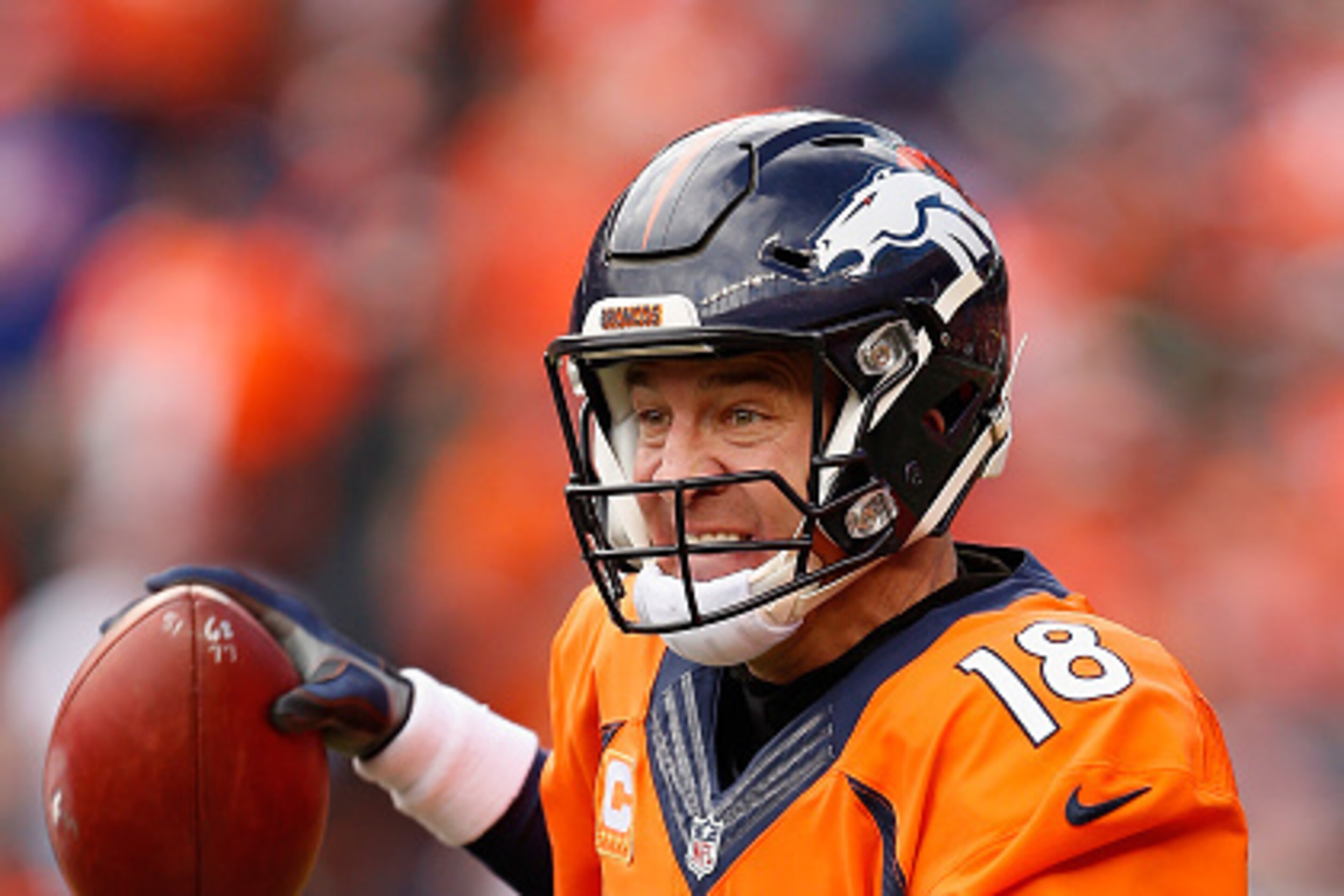DENVER, CO - JANUARY 24:  Quarterback Peyton Manning #18 of the Denver Broncos looks to pass during the AFC Championship game against the New England Patriots at Sports Authority Field at Mile High on January 24, 2016 in Denver, Colorado. The Broncos defe