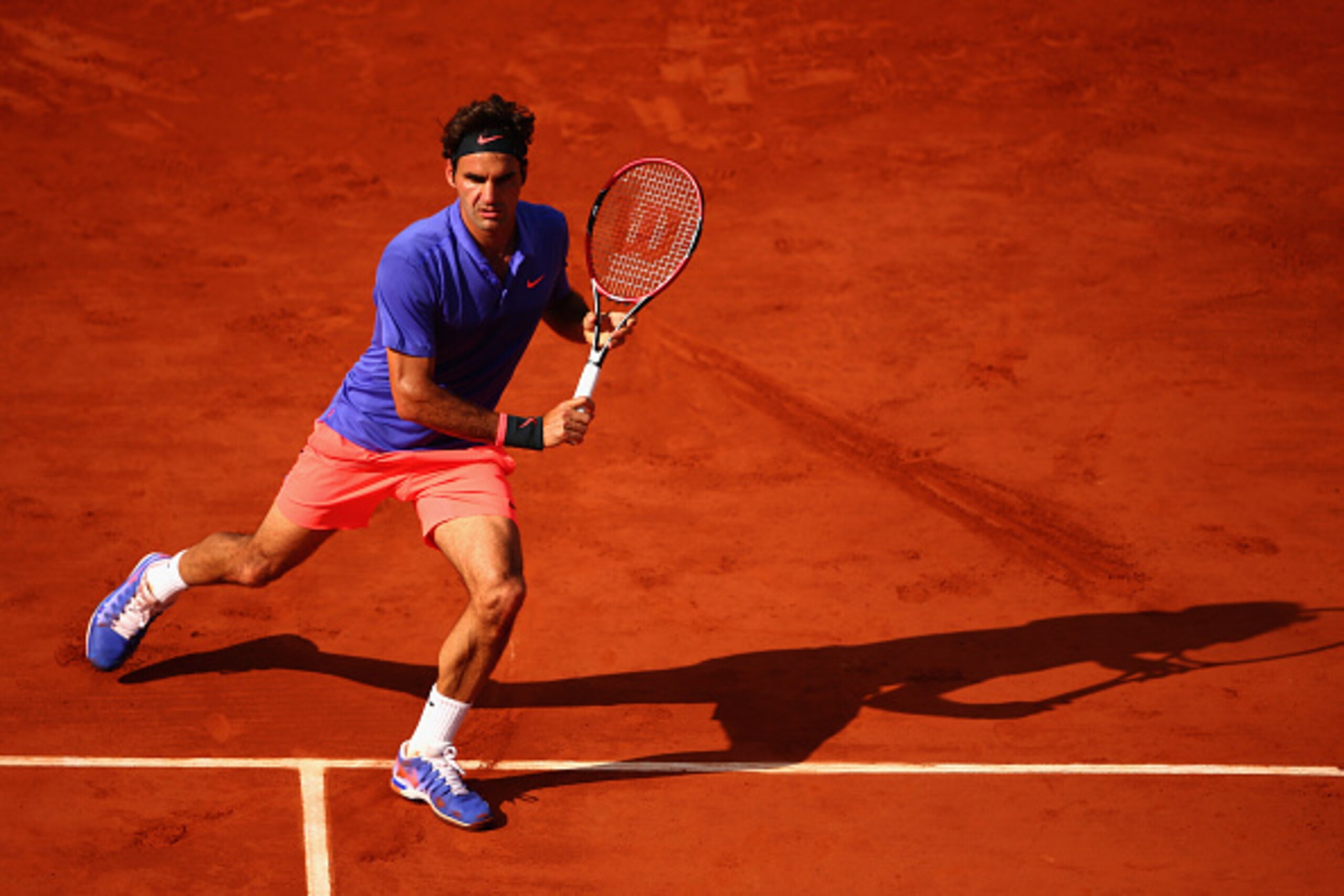 PARIS, FRANCE - JUNE 02:  Roger Federer of Switzerland returns a shot in his Men's quarter final match against Stanislas Wawrinka of Switzerland on day of the 2015 French Open at Roland Garros on June 2, 2015 in Paris, France.  (Photo by Clive Brunskill/G