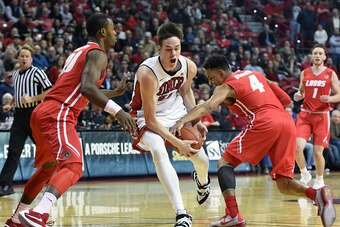 LAS VEGAS, NV - JANUARY 12:  Elijah Brown #4 of the New Mexico Lobos strips the ball from Stephen Zimmerman Jr. #33 of the UNLV Rebels as Sam Logwood #20 of the Lobos defends during their game at the Thomas & Mack Center on January 12, 2016 in Las Vegas,