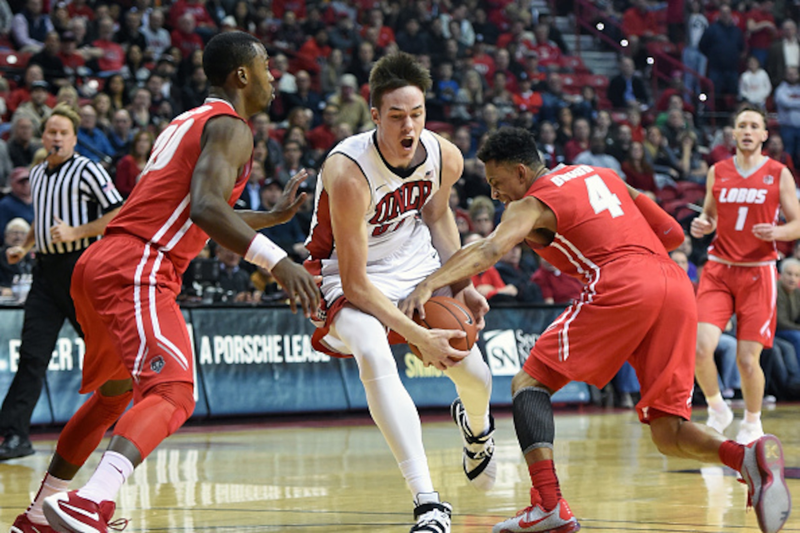 LAS VEGAS, NV - JANUARY 12: Elijah Brown #4 of the New Mexico Lobos strips the ball from Stephen Zimmerman Jr. #33 of the UNLV Rebels as Sam Logwood #20 of the Lobos defends during their game at the Thomas & Mack Center on January 12, 2016 in Las Vegas, LAS VEGAS, NV - JANUARY 12: Elijah Brown #4 of the New Mexico Lobos strips the ball from Stephen Zimmerman Jr. #33 of the UNLV Rebels as Sam Logwood #20 of the Lobos defends during their game at the Thomas & Mack Center on January 12, 2016 in Las Vegas,