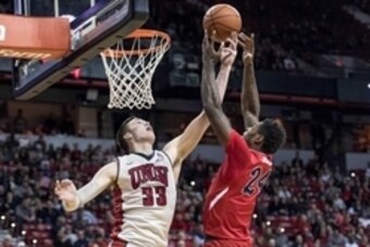 Dec 30, 2015; Las Vegas, NV, USA; UNLV Rebels forward Stephen Zimmerman Jr. (33) gets a hand up to block a shot by Fresno State Bulldogs forward Torren Jones (24) during the second half at Thomas & Mack Center. Fresno State won 69-66. Mandatory Credit: Jo
