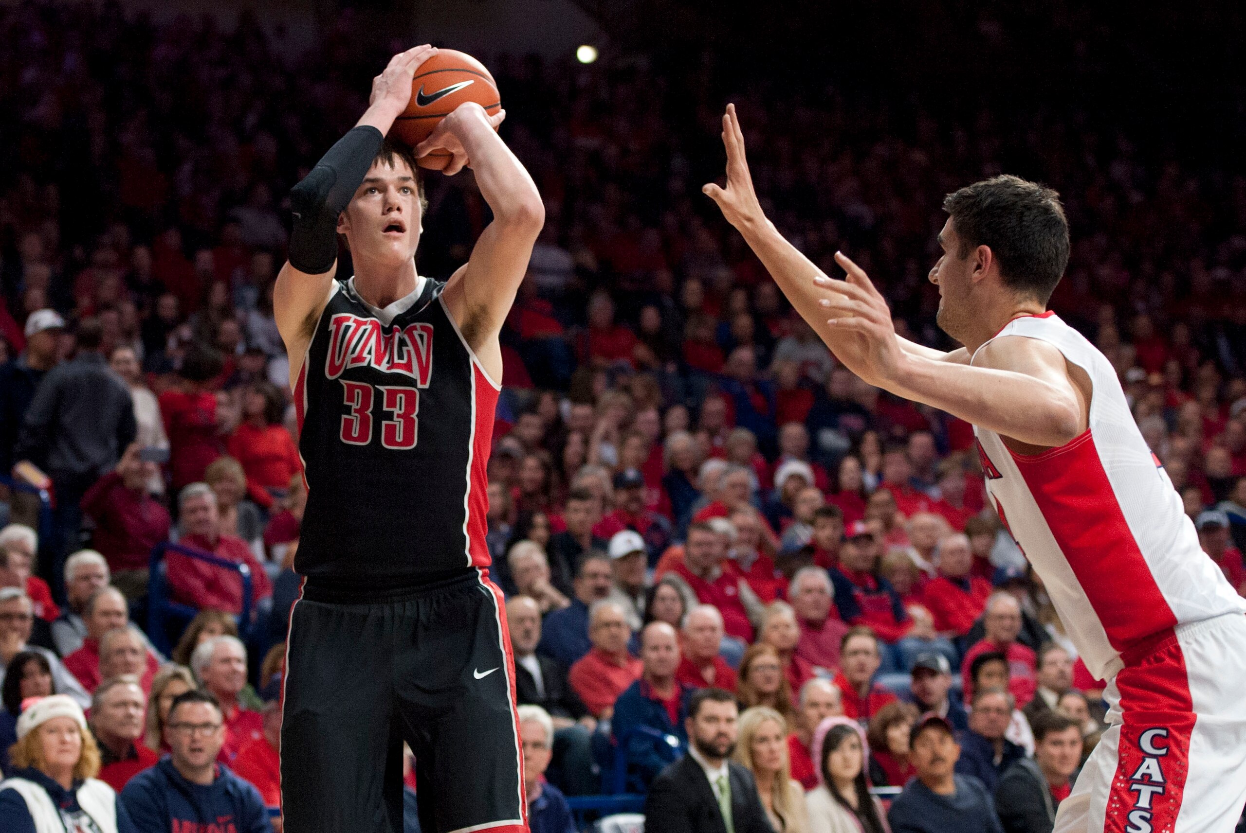 Dec 19, 2015; Tucson, AZ, USA; UNLV Rebels forward Stephen Zimmerman Jr. (33) shoots the ball as Arizona Wildcats center Dusan Ristic (14) defends during the first half at McKale Center. Mandatory Credit: Casey Sapio-USA TODAY Sports Dec 19, 2015; Tucson, AZ, USA; UNLV Rebels forward Stephen Zimmerman Jr. (33) shoots the ball as Arizona Wildcats center Dusan Ristic (14) defends during the first half at McKale Center. Mandatory Credit: Casey Sapio-USA TODAY Sports