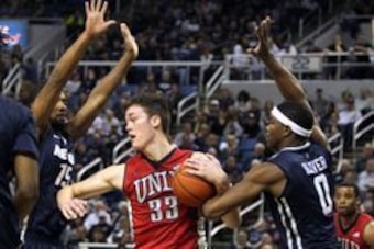 Jan 23, 2016; Reno, NV, USA; Nevada Wolf Pack 15 guard D.J. Fenner (15)  and forward Cameron Oliver (0) guard UNLV Rebels center Stephen Zimmerman Jr. (33) during the second half of their NCAA basketball game at Lawlor Events Center. Nevada won 65-63. Man