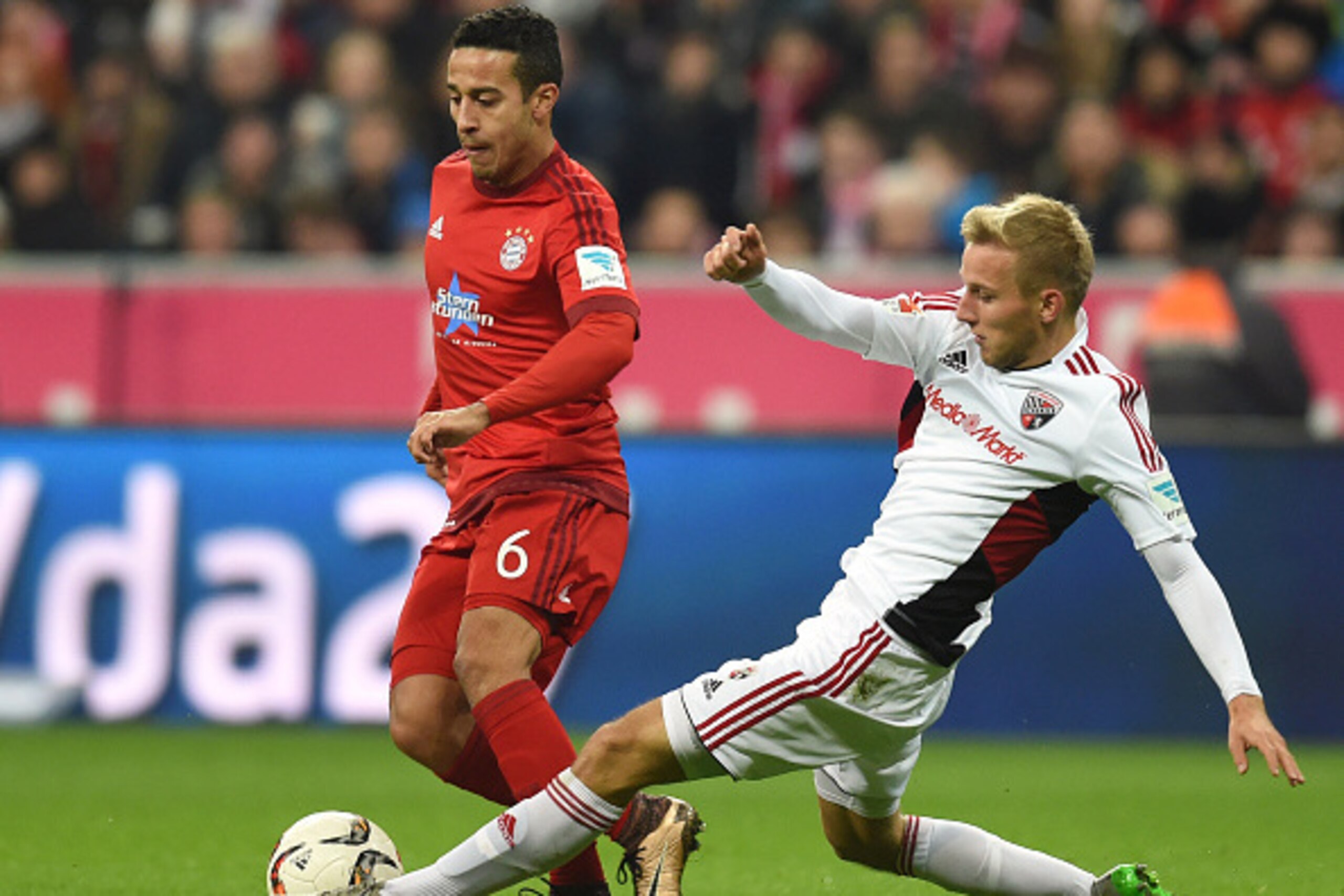 Bayern Munich's Spanish midfielder Thiago Alcantara (L) and Ingolstadt's midfielder Stefan Wannenwetsch (R) vie for the ball during the German first division Bundesliga football match FC Bayern Munich vs FC Ingolstadt 04 in Munich, southern Germany, on De