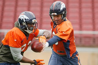 STANFORD, CA - FEBRUARY 03:  Peyton Manning #18 hands the ball off to C.J. Anderson #22 of the Denver Broncos during the Broncos practice for Super Bowl 50 at Stanford University on February 3, 2016 in Stanford, California. The Broncos will play the Carol