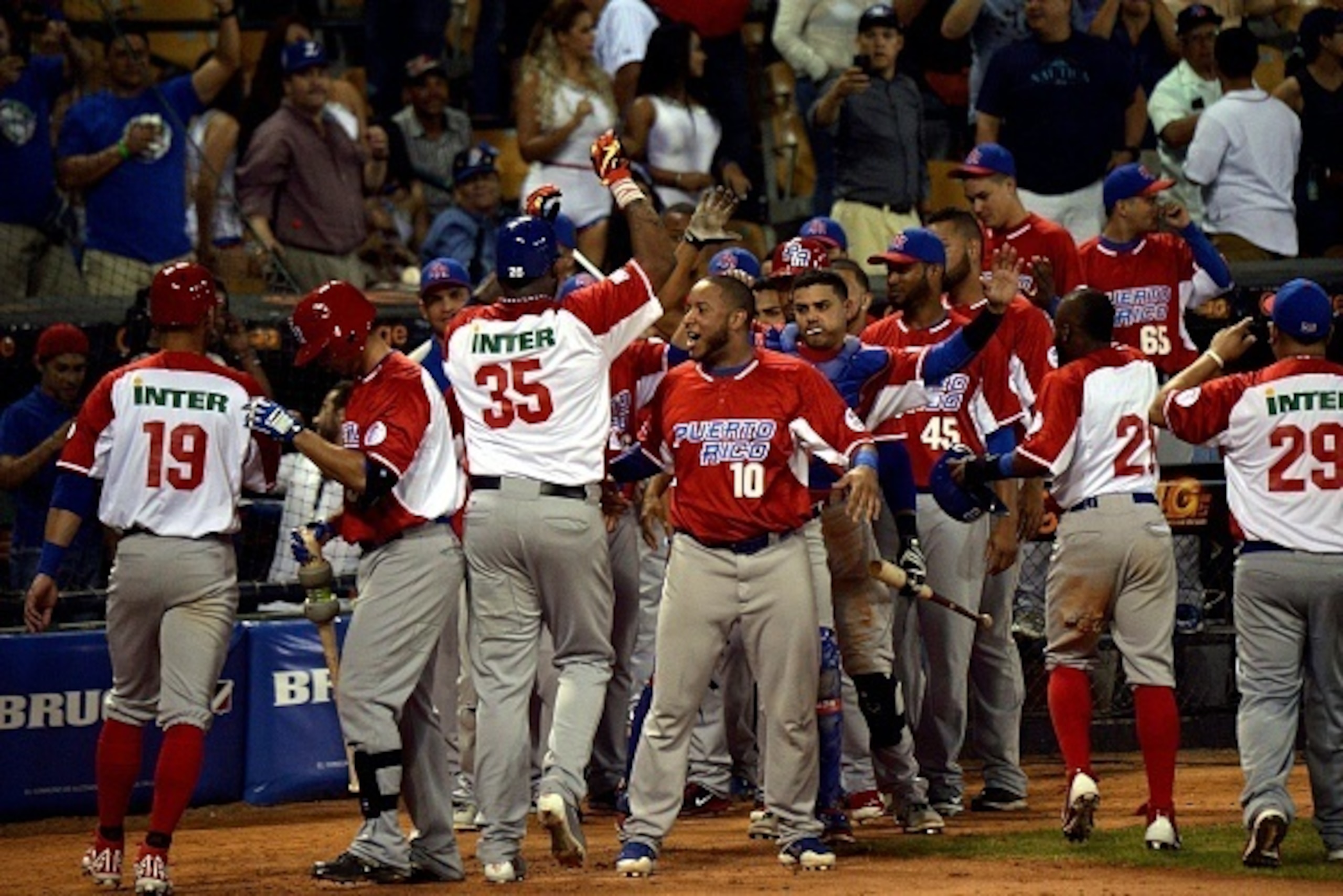 Kenny Vargas of Puerto Rican celebrates a homerun against Cuba during their 2016 Caribbean baseball series game on February 3, 2016 in Santo Domingo, Dominican Republic.  / AFP / YAMIL LAGE        (Photo credit should read YAMIL LAGE/AFP/Getty Images)