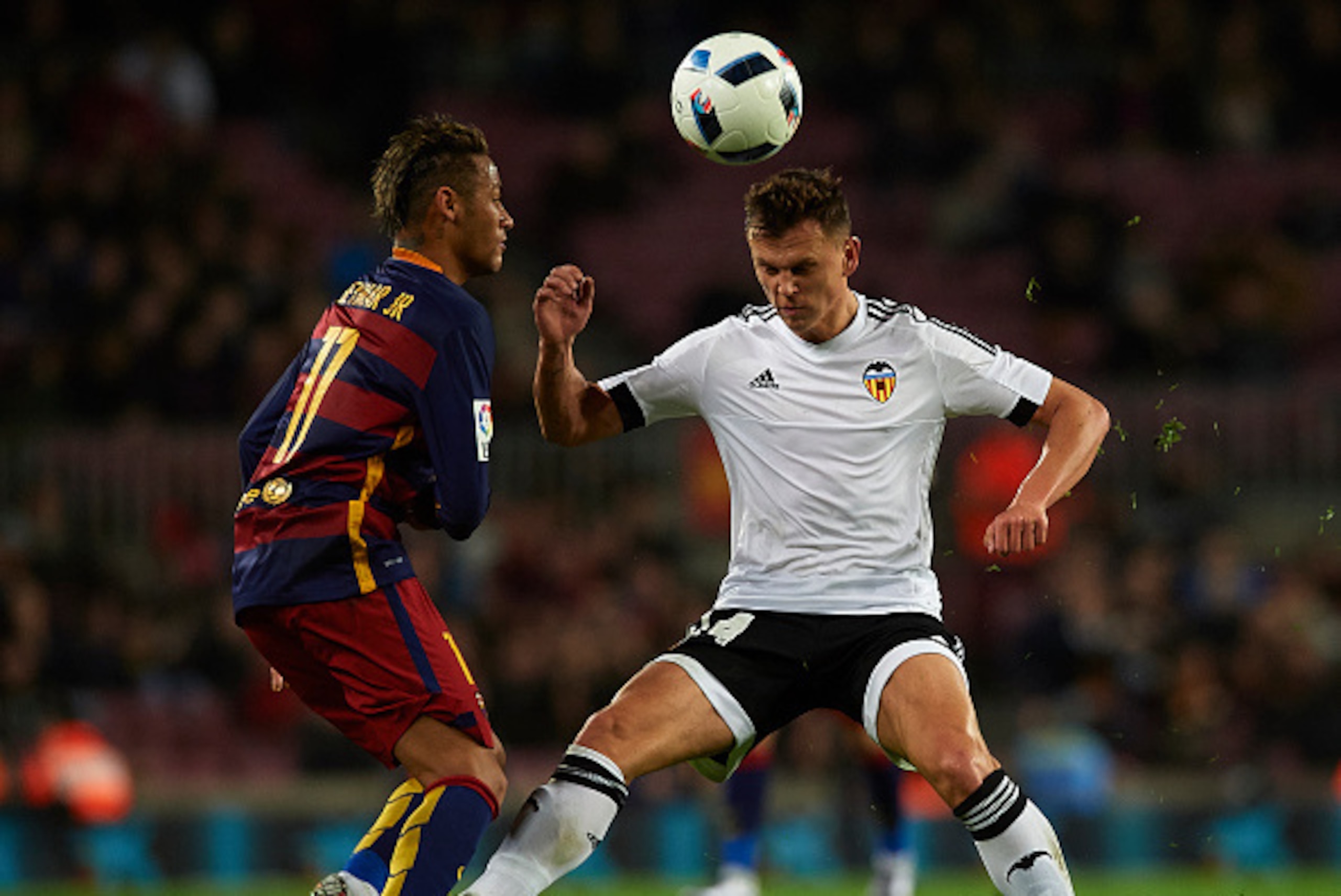BARCELONA, SPAIN - FEBRUARY 03:  Neymar JR of Barcelona is tackled by Denis Cheryshev (R) during the Copa del Rey Semi Final, first leg match between FC Barcelona and Valencia CF at Nou Camp on February 03, 2016 in Barcelona, Spain.  (Photo by Manuel Quei
