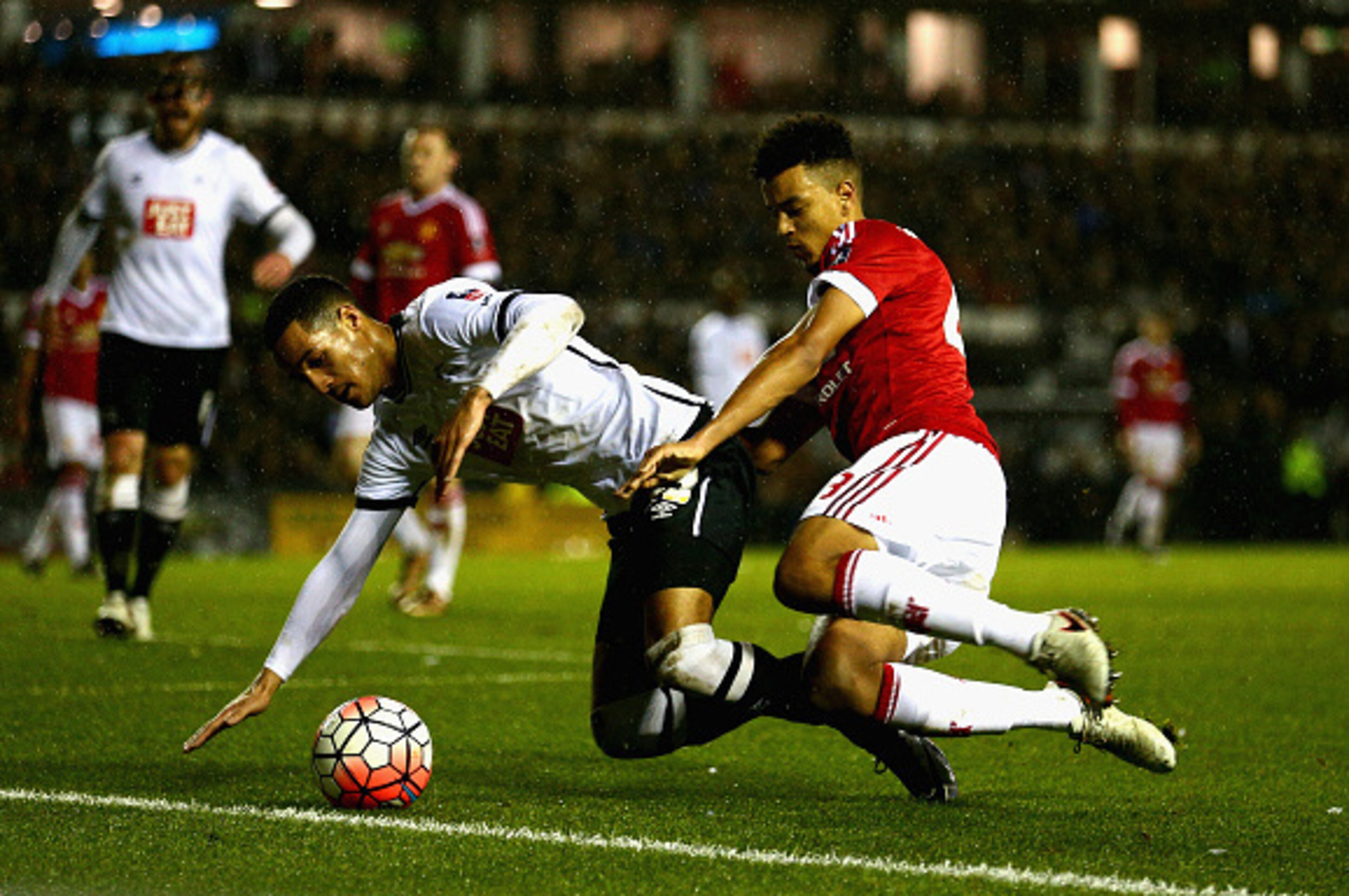 DERBY, ENGLAND - JANUARY 29:  Tom Ince of Derby County is tackled by Cameron Borthwick-Jackson of Manchester United during the Emirates FA Cup fourth round match between Derby County and Manchester United at Pride Park Stadium on January 29, 2016 in Derby