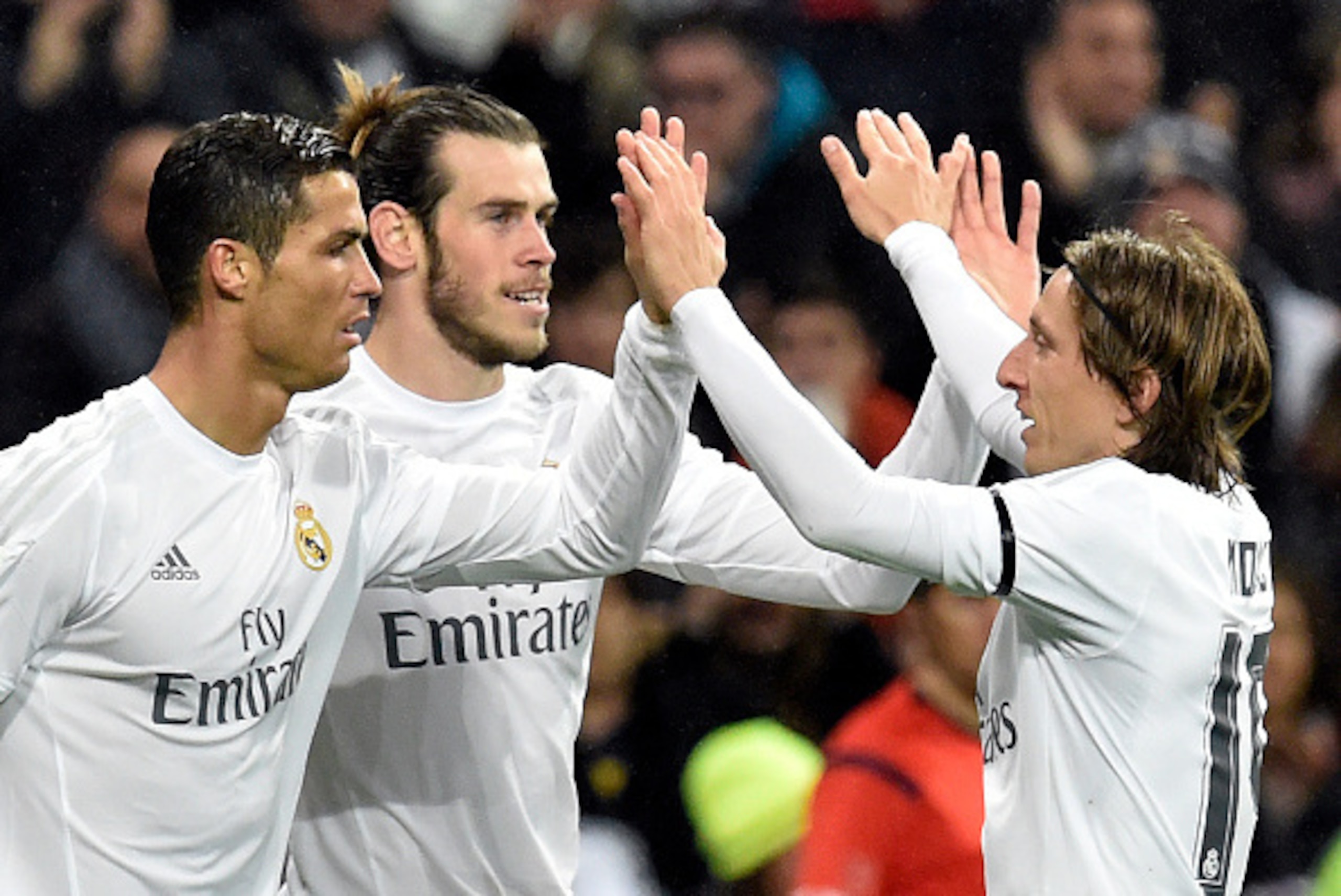 Real Madrid's Welsh forward Gareth Bale (C) is congratulated by Real Madrid's Portuguese forward Cristiano Ronaldo (L) and Real Madrid's Croatian midfielder Luka Modric after scoring during the Spanish league football match Real Madrid CF vs RC Deportivo Real Madrid's Welsh forward Gareth Bale (C) is congratulated by Real Madrid's Portuguese forward Cristiano Ronaldo (L) and Real Madrid's Croatian midfielder Luka Modric after scoring during the Spanish league football match Real Madrid CF vs RC Deportivo