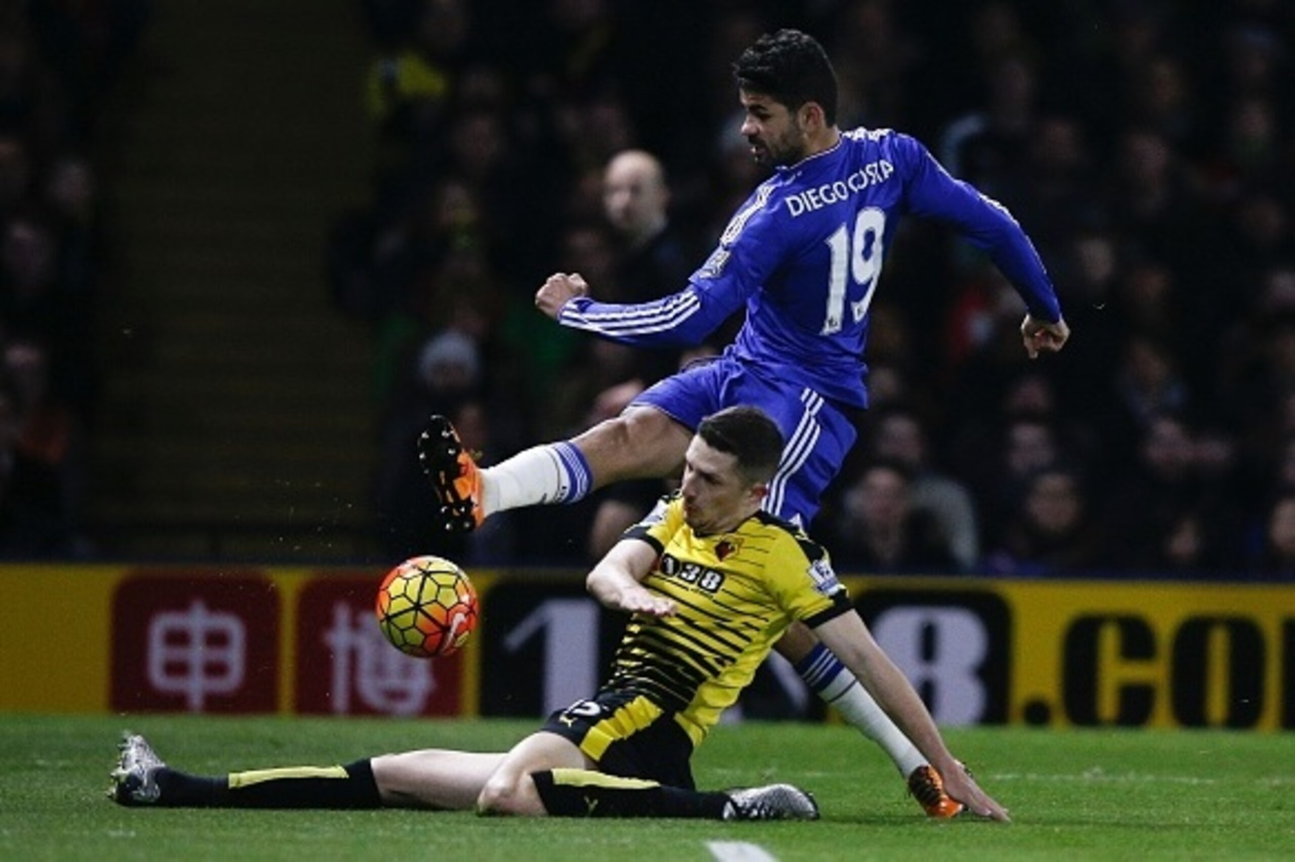 A shot by Chelsea's Brazilian-born Spanish striker Diego Costa (R) is blocked by Watford's Northern Irish defender Craig Cathcart (floor) during the English Premier League football match between Watford and Chelsea at Vicarage Road Stadium in Watford, nor