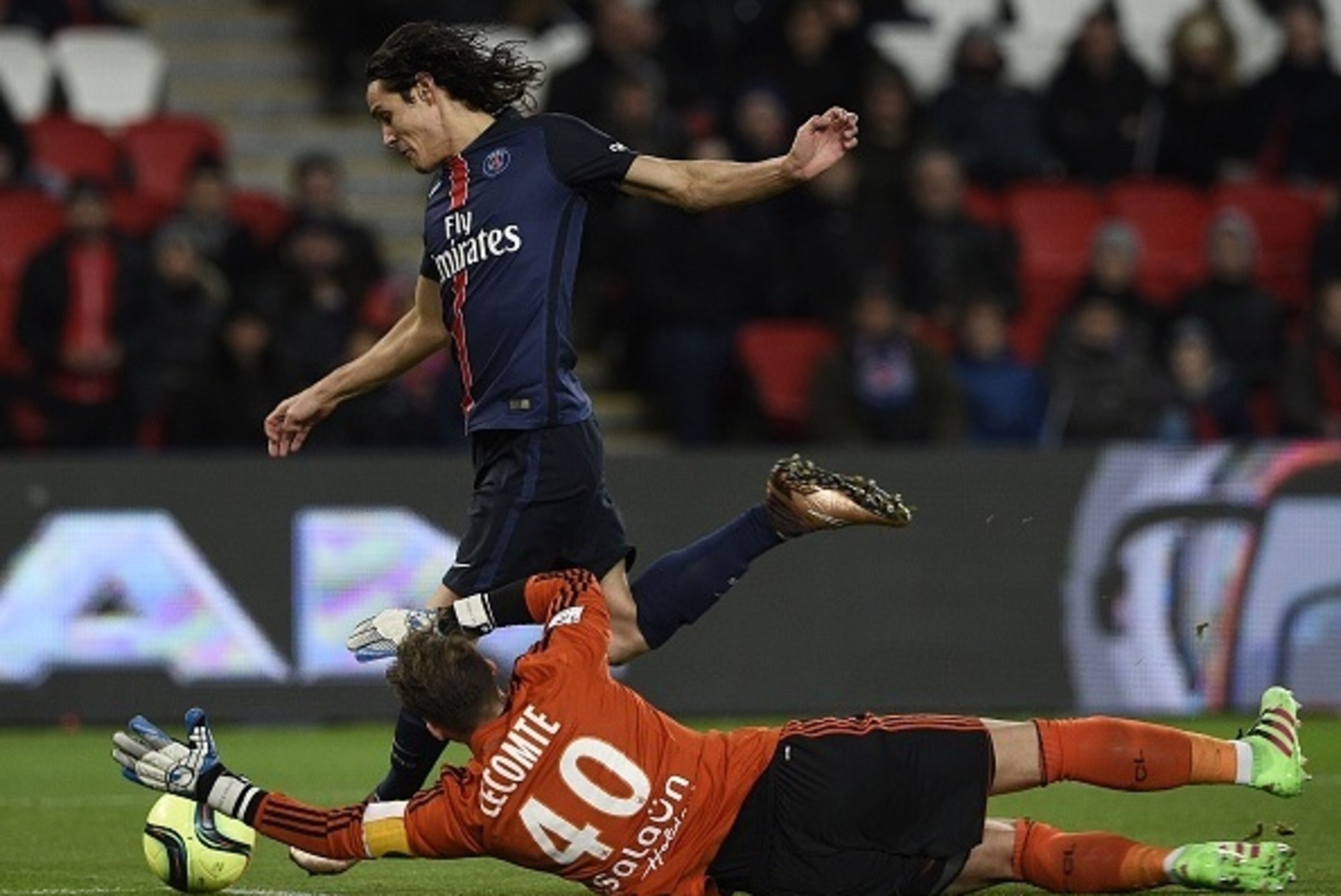 Paris Saint-Germain's Uruguyan forward Edinson Cavani (L) scores a goal despite Lorient's French goalkeeper Benjamin Lecomte during the French L1 football match between Paris Saint-Germain (PSG) and Lorient on February 3, 2016 at the Parc des Princes stad
