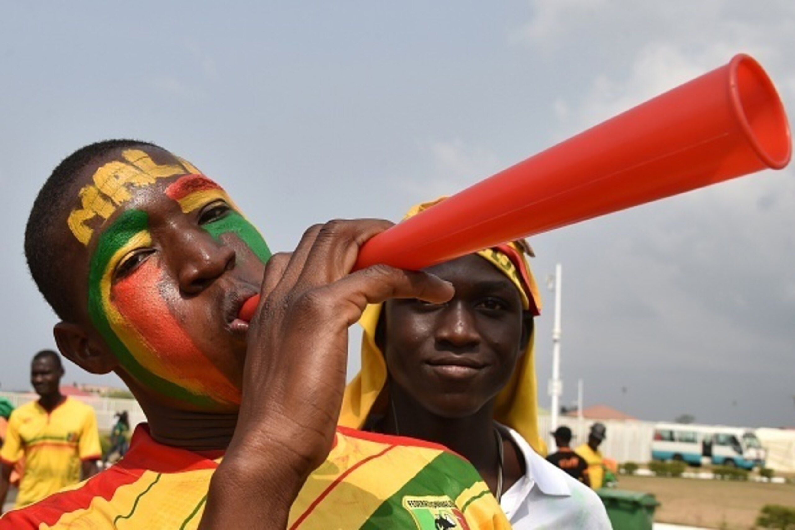 Malian fans cheer for their team as they arrive to attend the 2015 African Cup of Nations group D football match between Ivory Coast and Mali in Malabo on January 24, 2015. AFP PHOTO / ISSOUF SANOGO        (Photo credit should read ISSOUF SANOGO/AFP/Getty
