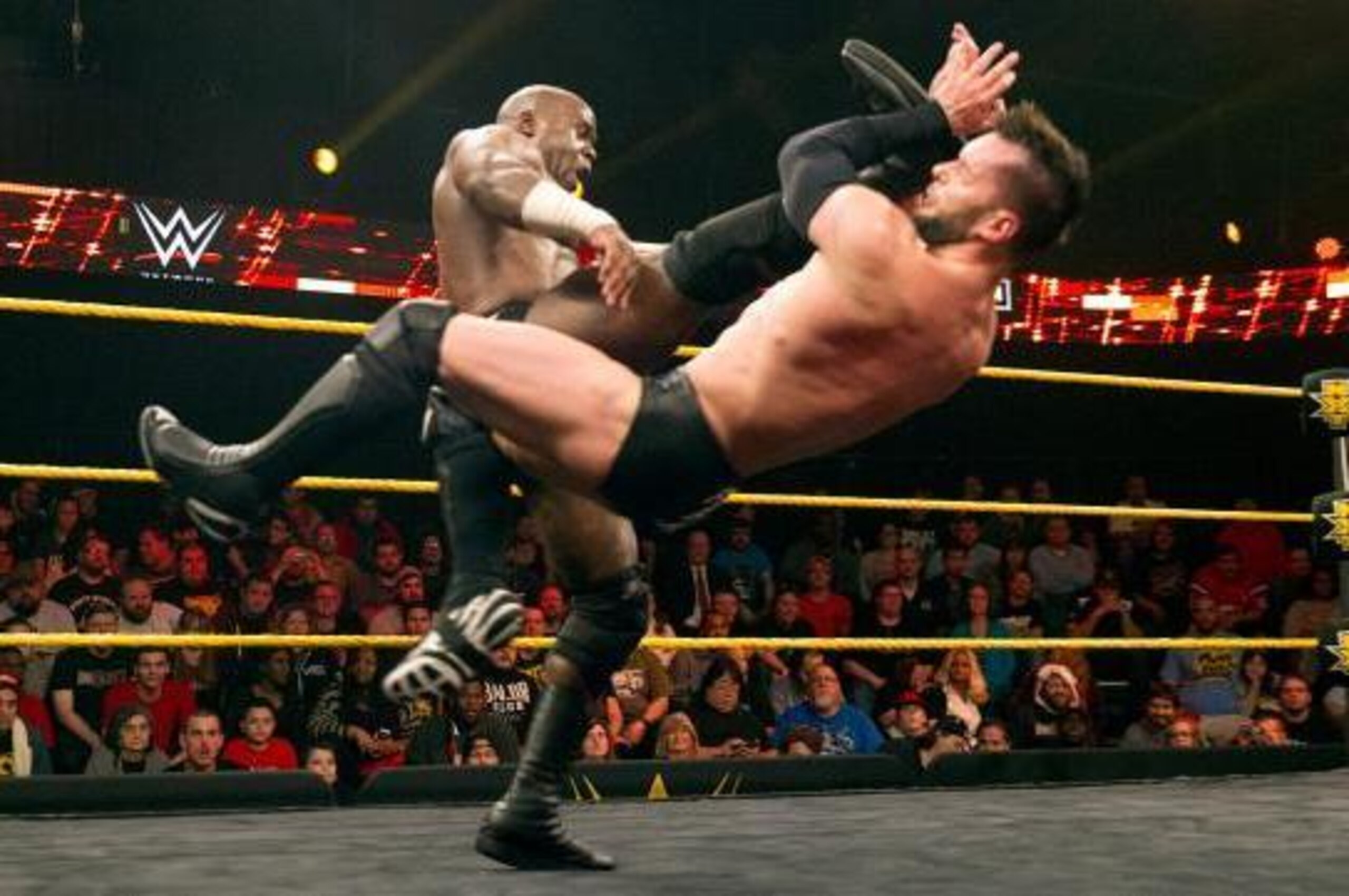 Apollo Crews nails Finn Balor with a kick.