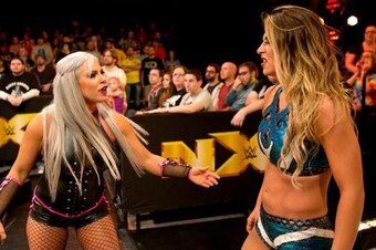 Dana Brooke and Emma share a tense moment.