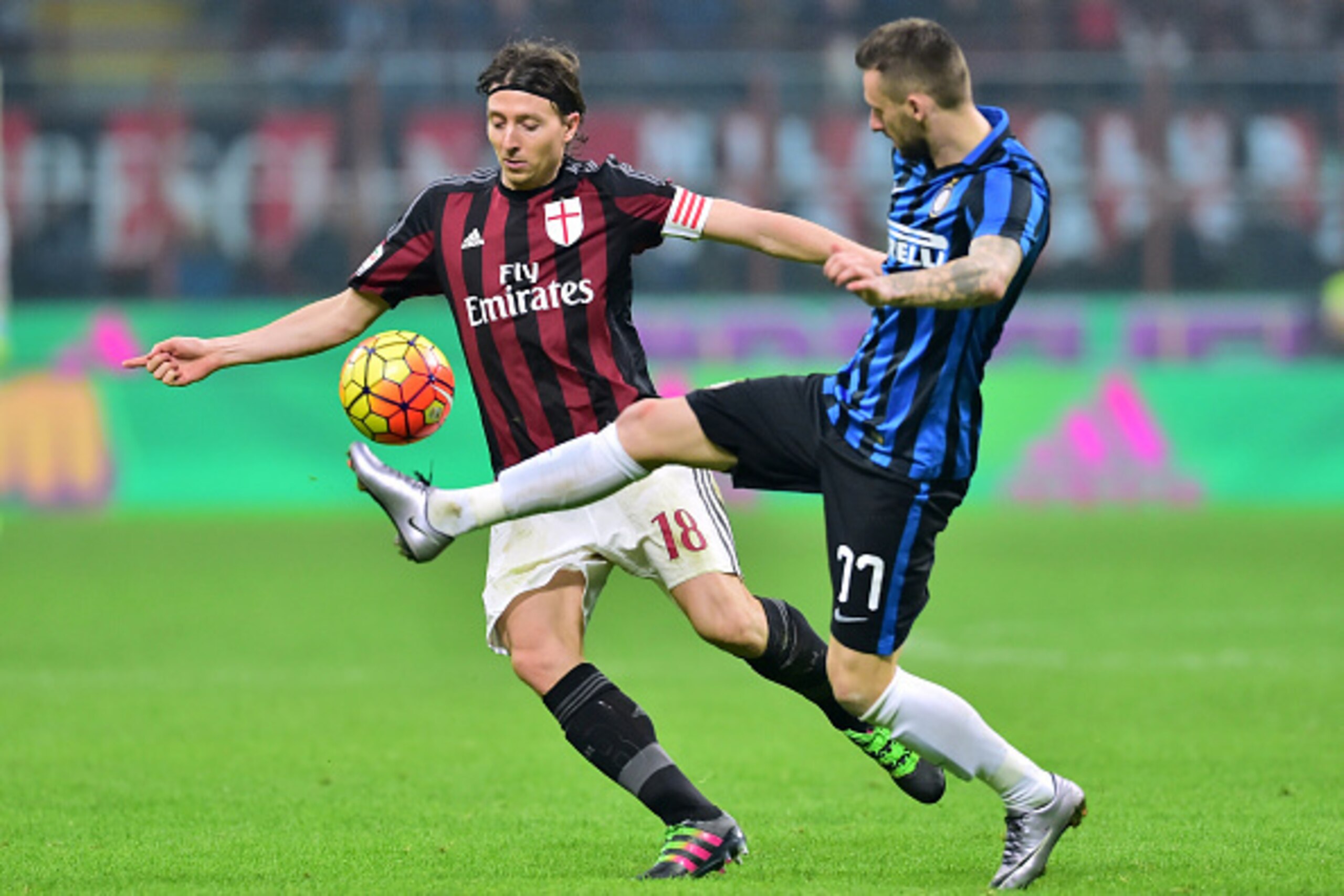 Inter Milan's Croatian midfielder Marcelo Brozovic (R) vies for the ball with AC Milan's Italian midfielder Riccardo Montolivo during the Italian Serie A football match between AC Milan and Inter Milan at San Siro Stadium in Milan on January 31, 2016. / A