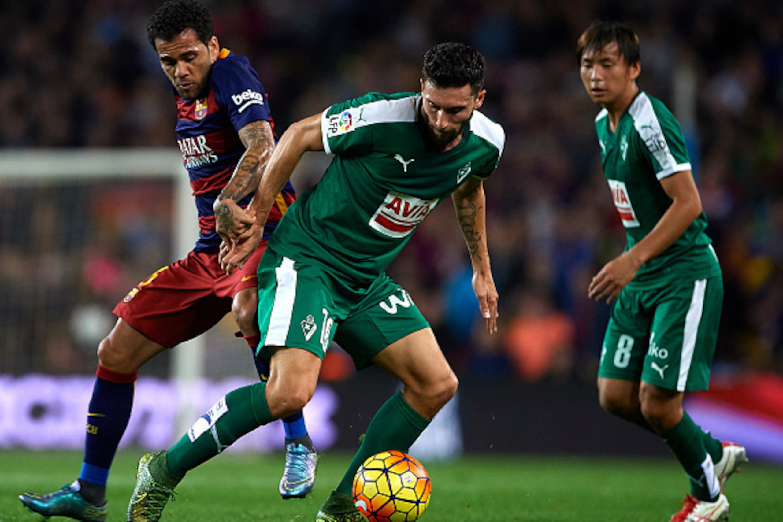 BARCELONA, SPAIN - OCTOBER 25: Daniel Alves (L) of Barcelona competes for the ball with Borja Gonzalez Tomas 'Baston' of Eibar during the La Liga match between FC Barcelona and SD Eibar at Camp Nou Stadium on October 25, 2015 in Barcelona, Spain. (Photo BARCELONA, SPAIN - OCTOBER 25: Daniel Alves (L) of Barcelona competes for the ball with Borja Gonzalez Tomas 'Baston' of Eibar during the La Liga match between FC Barcelona and SD Eibar at Camp Nou Stadium on October 25, 2015 in Barcelona, Spain. (Photo