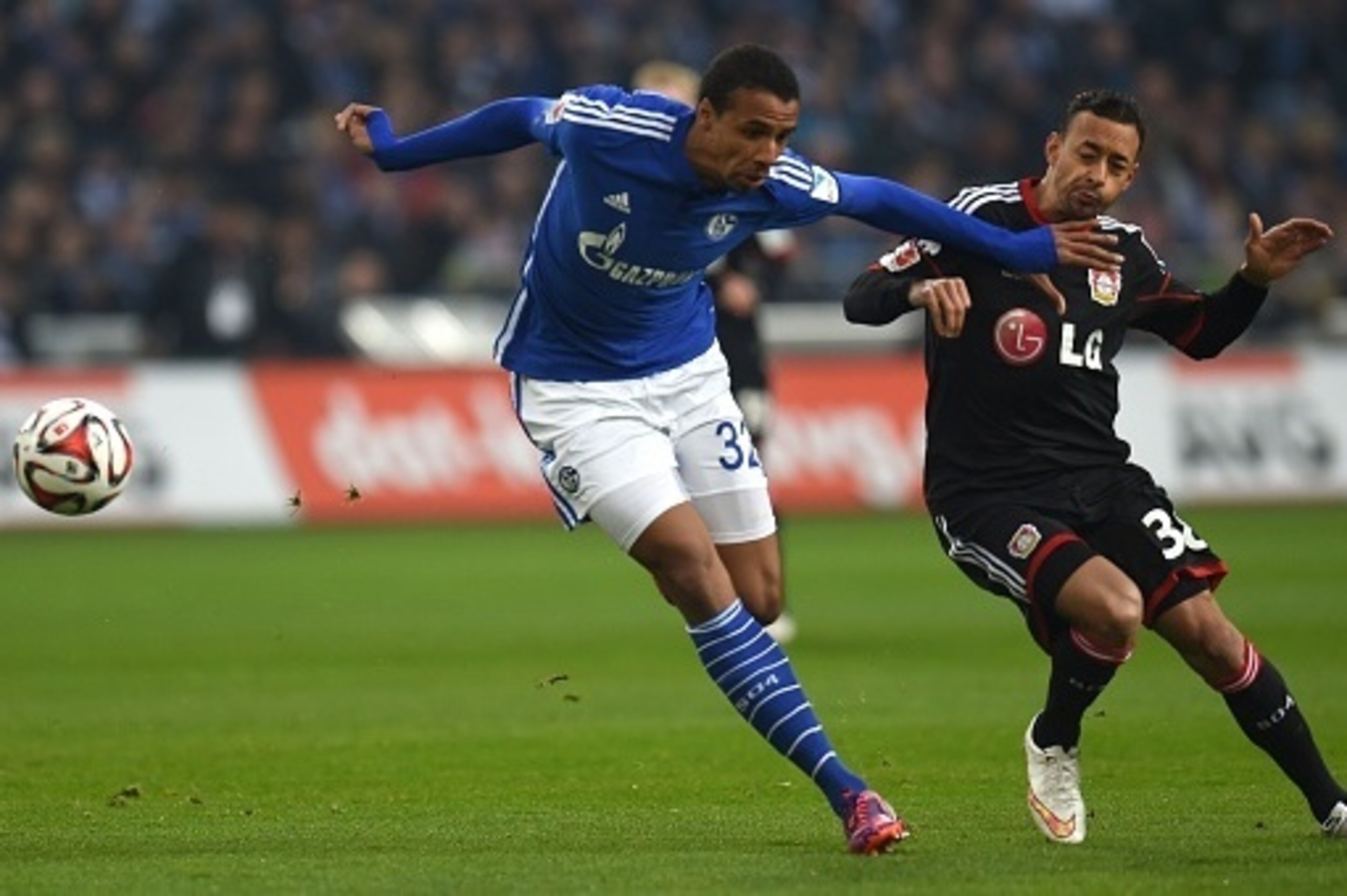 Schalke's Cameroonian defender Joel Matip (L) and Leverkusen's forward Karim Bellarabi vie for the ball during the German first division Bundesliga football match FC Schalke 04 vs Bayer Leverkusen in Gelsenkirchen, western Germany, on March 21, 2015.  AFP