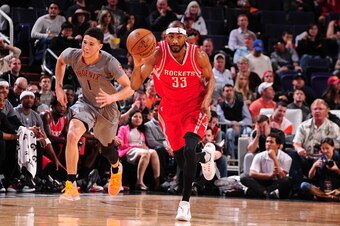PHOENIX, AZ - FEBRUARY 4: Corey Brewer #33 of the Houston Rockets brings the ball up court against the Phoenix Suns on February 4, 2016, at Talking Stick Resort Arena in Phoenix, Arizona. NOTE TO USER: User expressly acknowledges and agrees that, by downl