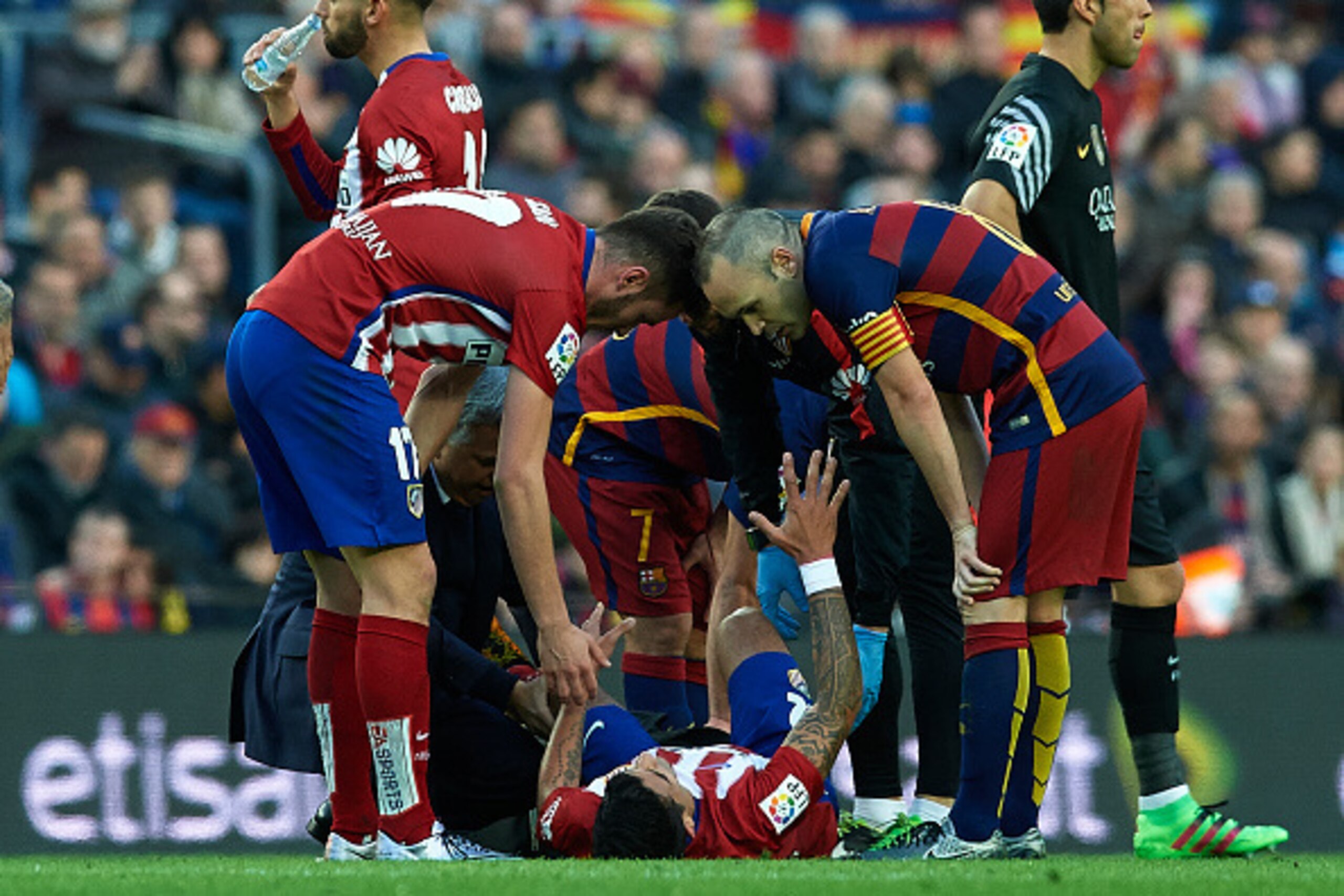 BARCELONA, SPAIN - JANUARY 30:  Augusto Fernandez of Atletico de Madrid lies injured on the pitch during the La Liga match between FC Barcelona and Atletico de Madrid at Camp Nou on January 30, 2016 in Barcelona, Spain.  (Photo by Manuel Queimadelos Alons