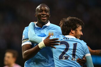 MANCHESTER, ENGLAND - DECEMBER 26:  Yaya Toure of Manchester City is congratulated by teammate David Silva after scoring his team's second goal during the Barclays Premier League match between Manchester City and Sunderland at the Etihad Stadium on Decemb