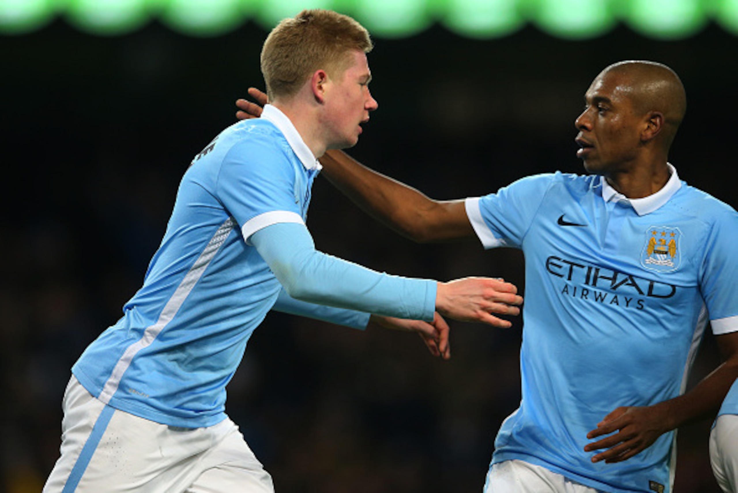 MANCHESTER, ENGLAND - JANUARY 27:  (L-R) Kevin De Bruyne of Manchester City is congratulated by teammate Fernandinho after scoring his team;s second goal  during the Capital One Cup Semi Final, second leg match between Manchester City and Everton at the E