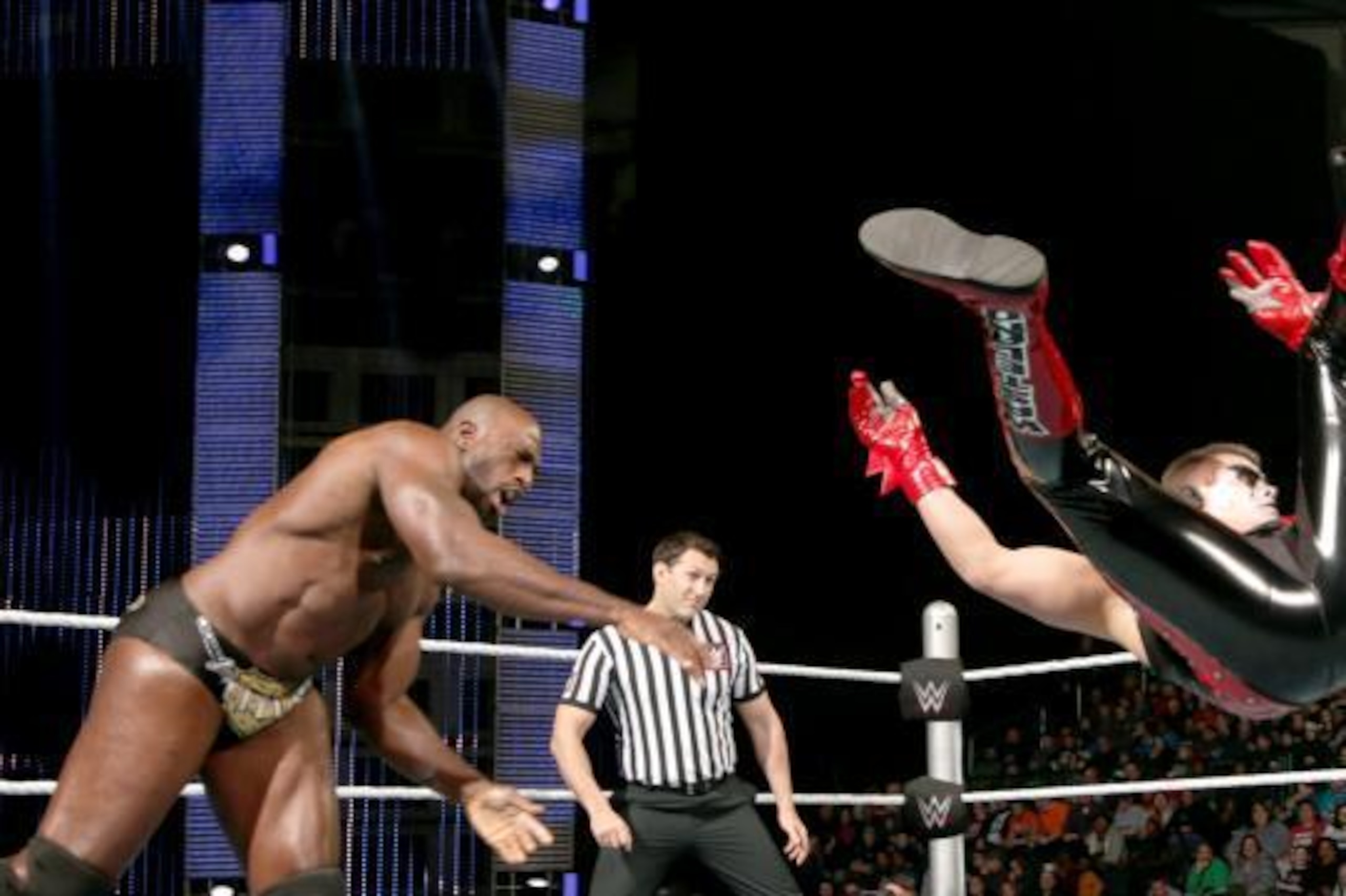 TItus O'Neil hurls Stardust across the ring.