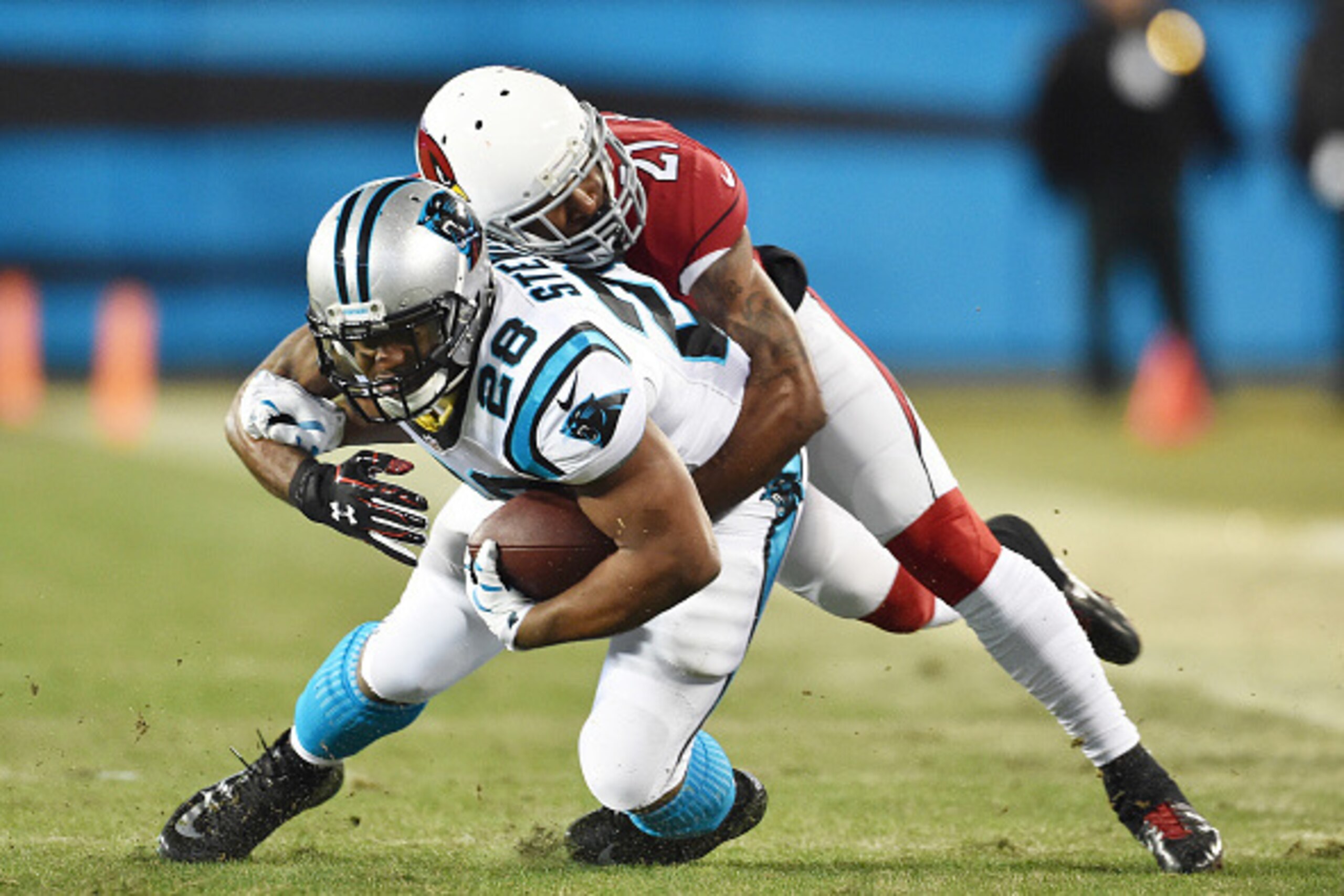 CHARLOTTE, NC - JANUARY 24:  Running back Jonathan Stewart #28 of the Carolina Panthers is tackled by Patrick Peterson #21 of the Arizona Cardinals during the NFC Championship Game at Bank of America Stadium on January 24, 2016 in Charlotte, North Carolin