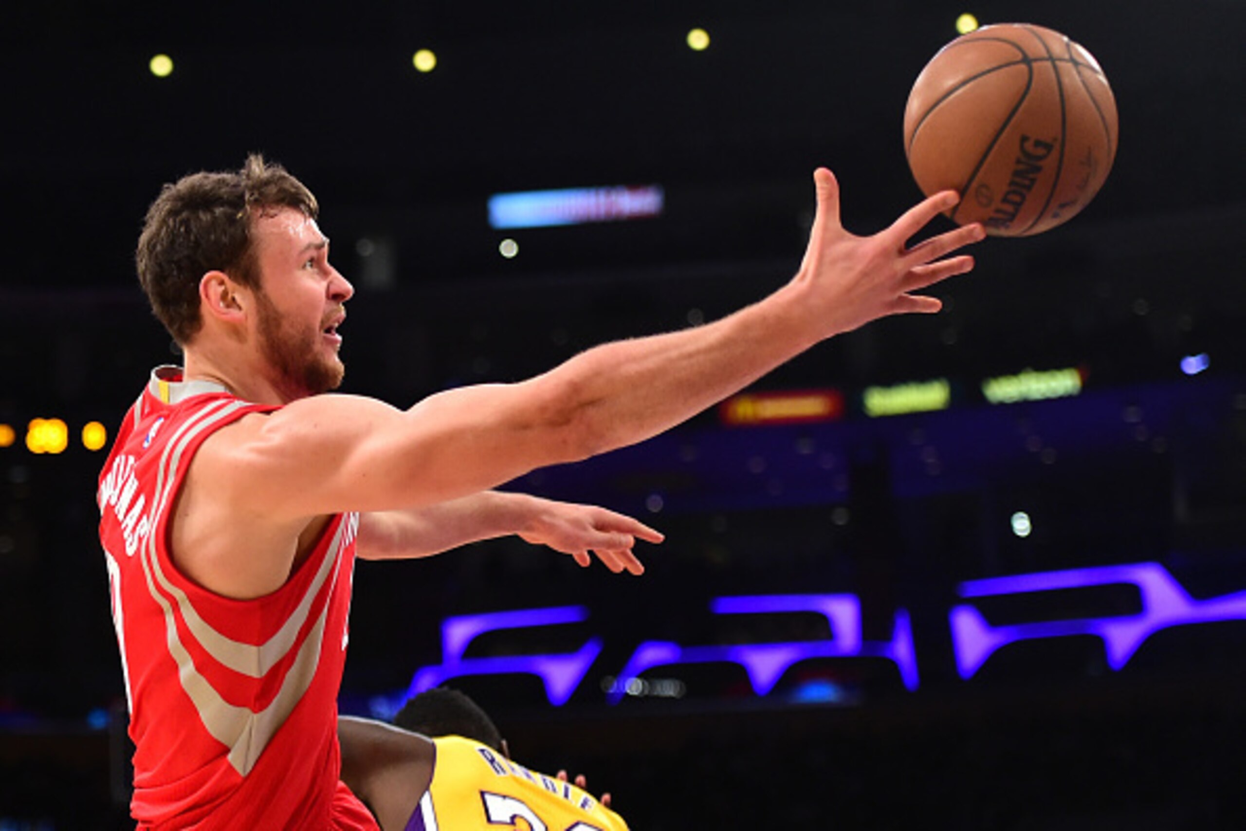LOS ANGELES, CA - DECEMBER 17:  Donatas Motiejunas #20 of the Houston Rockets is fouled as he shoots by Julius Randle #30 of the Los Angeles Lakers during the first half at Staples Center on December 17, 2015 in Los Angeles, California.  NOTE TO USER: Use