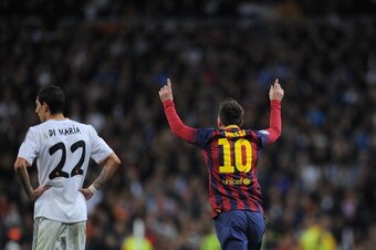MADRID, SPAIN - MARCH 23: Lionel Messi of Barcelona celebrates beside Angel Di Maria of Real Madrid after scoring his team's third goal during the La Liga match between Real Madrid CF and FC Barcelona at the Bernabeu on March 23, 2014 in Madrid, Spain.  (