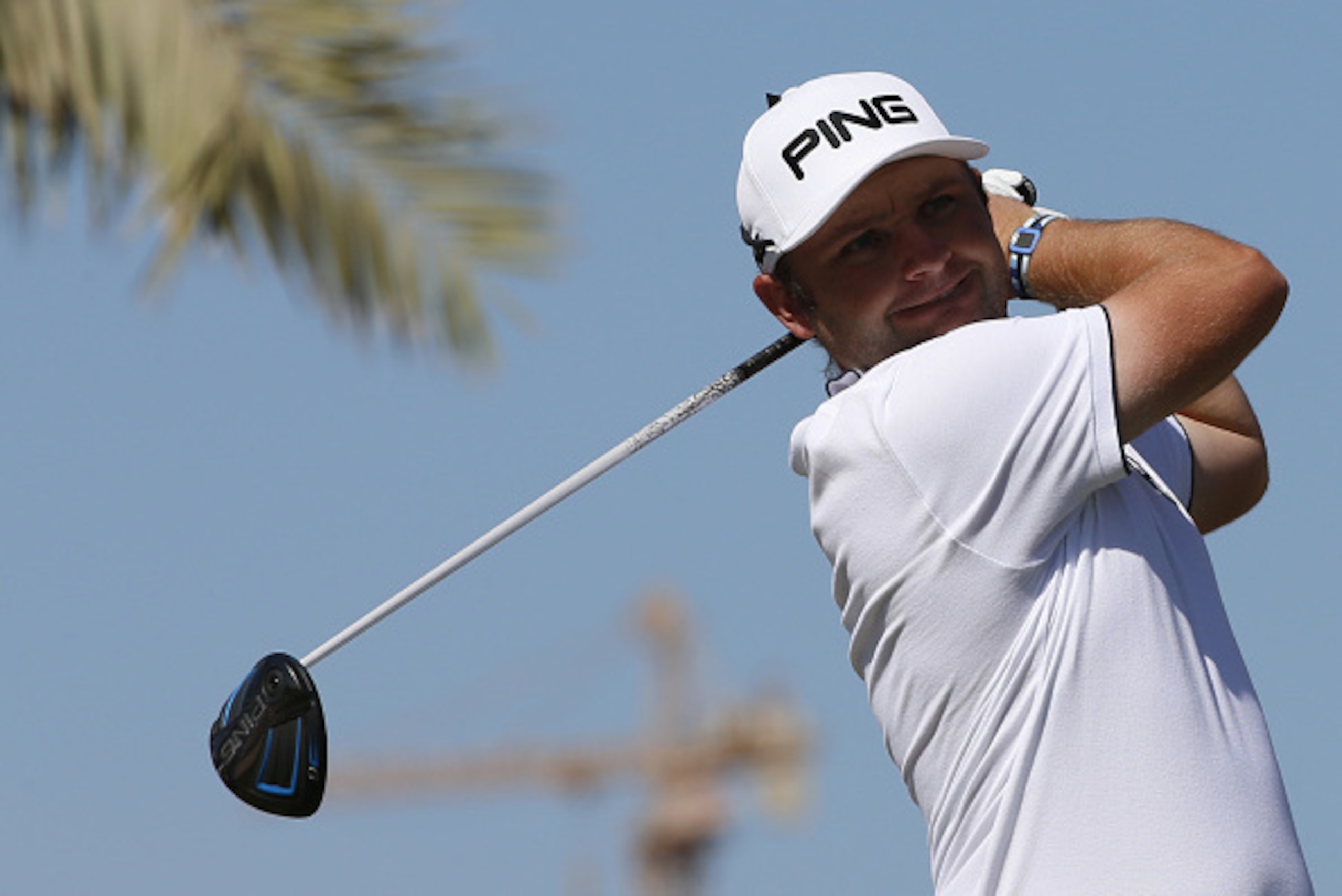 Andy Sullivan of England plays a shot during the third round of the 2016 Dubai Desert Classic at the Emirates Golf Club in Dubai on February 6, 2016. / AFP / KARIM SAHIB        (Photo credit should read KARIM SAHIB/AFP/Getty Images)