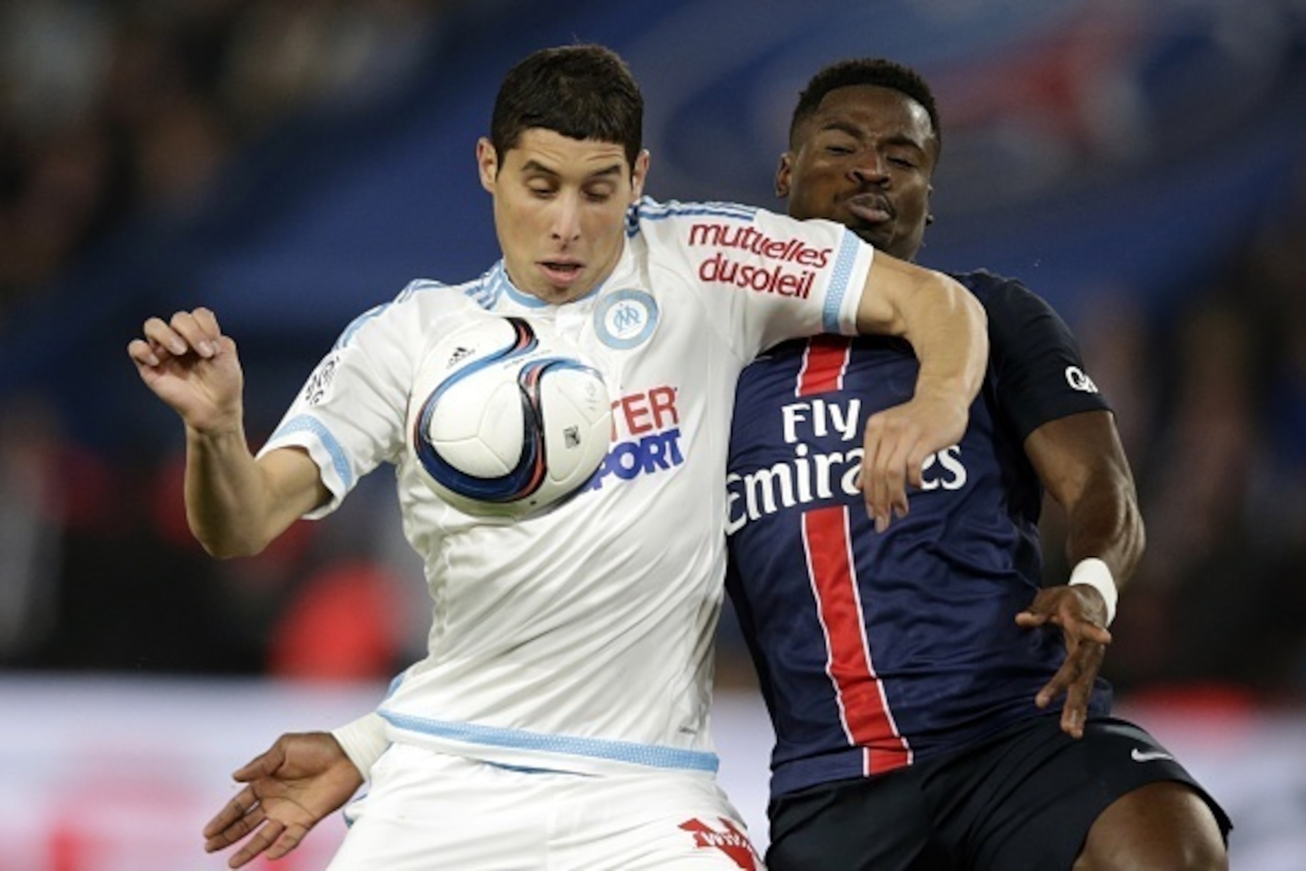 Paris Saint-Germain's Ivorian defender Serge Aurier (R) vies with Marseille's Moroccan midfielder Abdelaziz Barrada during the French L1 football match Paris Saint-Germain (PSG) vs Olympique de Marseille (OM) on October 4, 2015 at the Parc des Princes sta