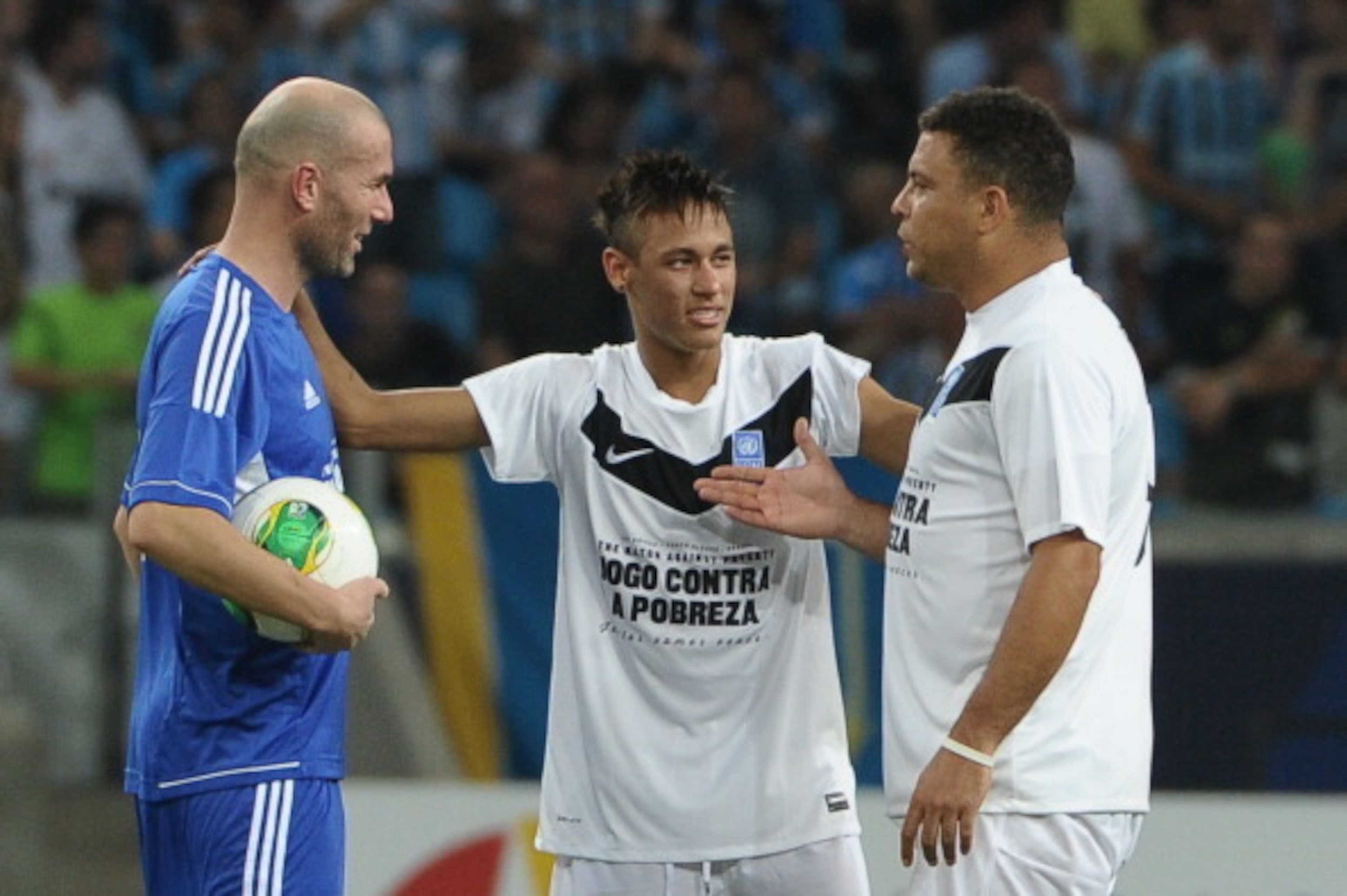 Brazilian football players Neymar (C) and Ronaldo (R) and French football player Zidane speaks before the second half during the 'Match Against Poverty' friendly football match led by the United Nations Development Programme (UNDP), between the teams 'Fri