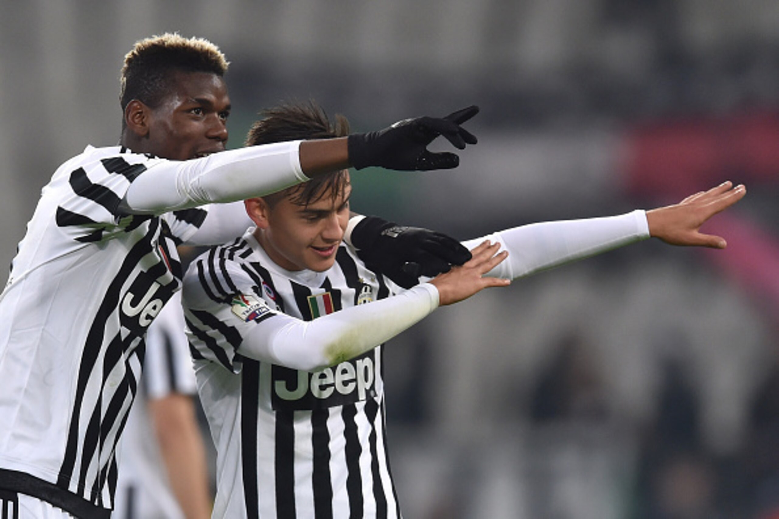 TURIN, ITALY - DECEMBER 16:  Paul Pogba (L) and Paulo Dybala of FC Juventus celebrate victory at the end of the TIM Cup match between FC Juventus and Torino FC at Juventus Arena on December 16, 2015 in Turin, Italy.  (Photo by Valerio Pennicino/Getty Imag