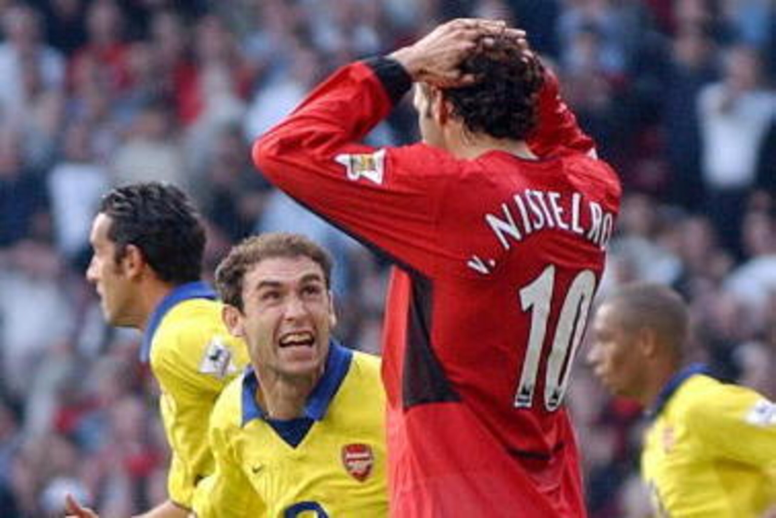 Martin Keown of Arsenal taunts Ruud Van Nistelrooy of Manchester United after a missed a penalty given away by Keown in the final minutes of their Premiership clash at Old Trafford 21 September 2003 in Manchester. AFP PHOTO Paul BARKER (Photo credit shou Martin Keown of Arsenal taunts Ruud Van Nistelrooy of Manchester United after a missed a penalty given away by Keown in the final minutes of their Premiership clash at Old Trafford 21 September 2003 in Manchester. AFP PHOTO Paul BARKER (Photo credit shou