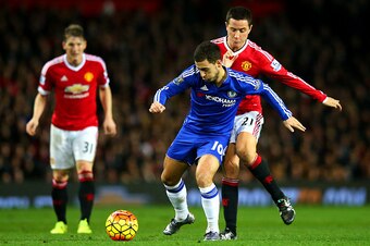 MANCHESTER, ENGLAND - DECEMBER 28:  Eden Hazard of Chelsea battles for the ball with Ander Herrera of Manchester United during the Barclays Premier League match between Manchester United and Chelsea at Old Trafford on December 28, 2015 in Manchester, Engl