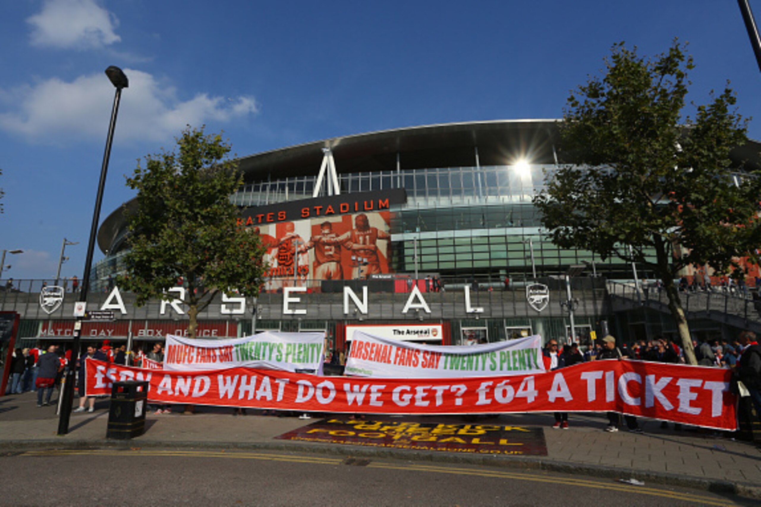 LONDON, ENGLAND - OCTOBER 04:  Arsenal and Manchester United fans protest about high ticket prices with banners outside the stadium before the Barclays Premier League match between Arsenal and Manchester United at the Emirates Stadium on October 04, 2015 