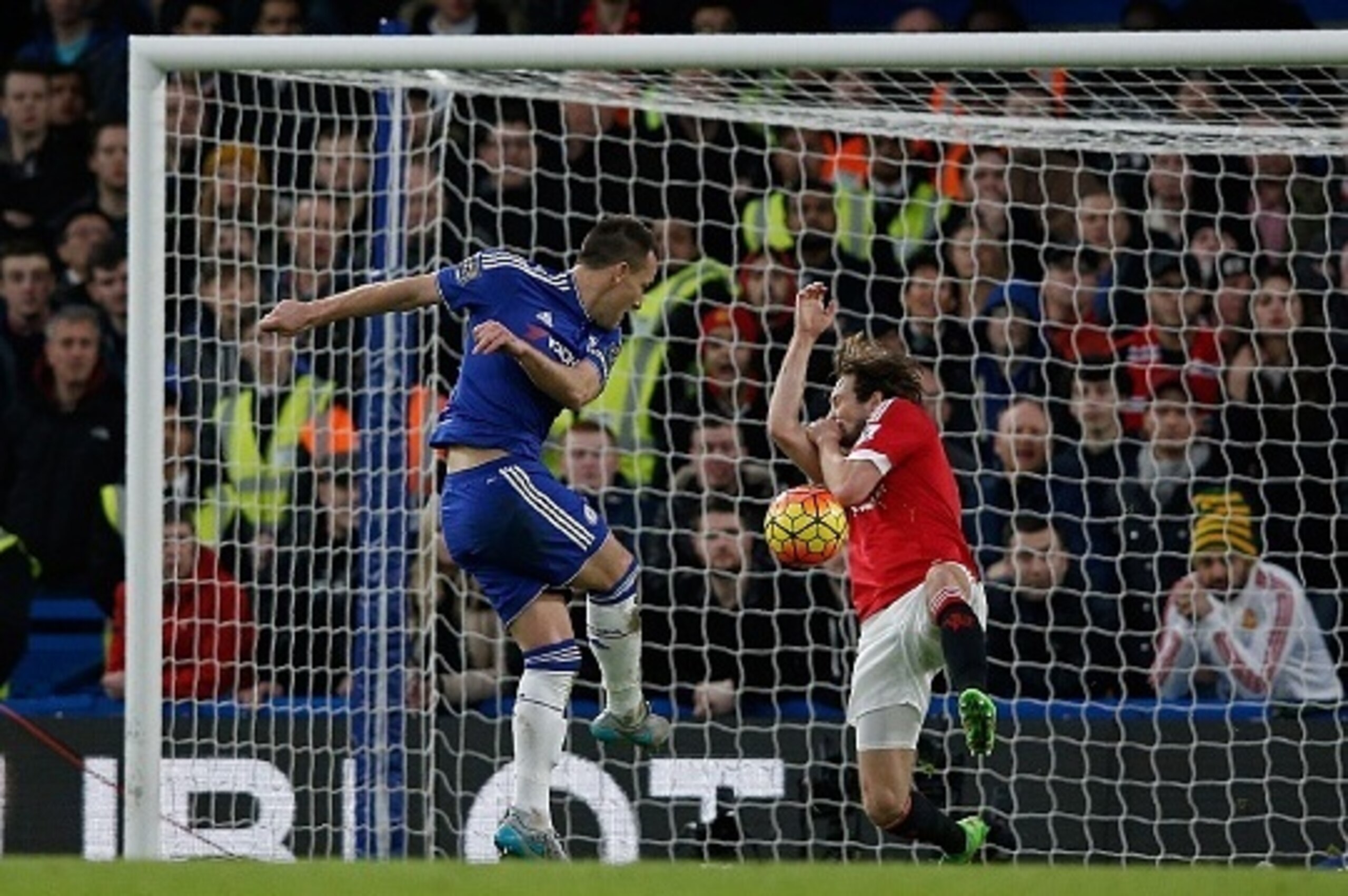 Chelsea's English defender John Terry (L) has a shot on goal blocked by Manchester United's Dutch midfielder Daley Blind during the English Premier League football match between Chelsea and Manchester United at Stamford Bridge in London on February 7, 201