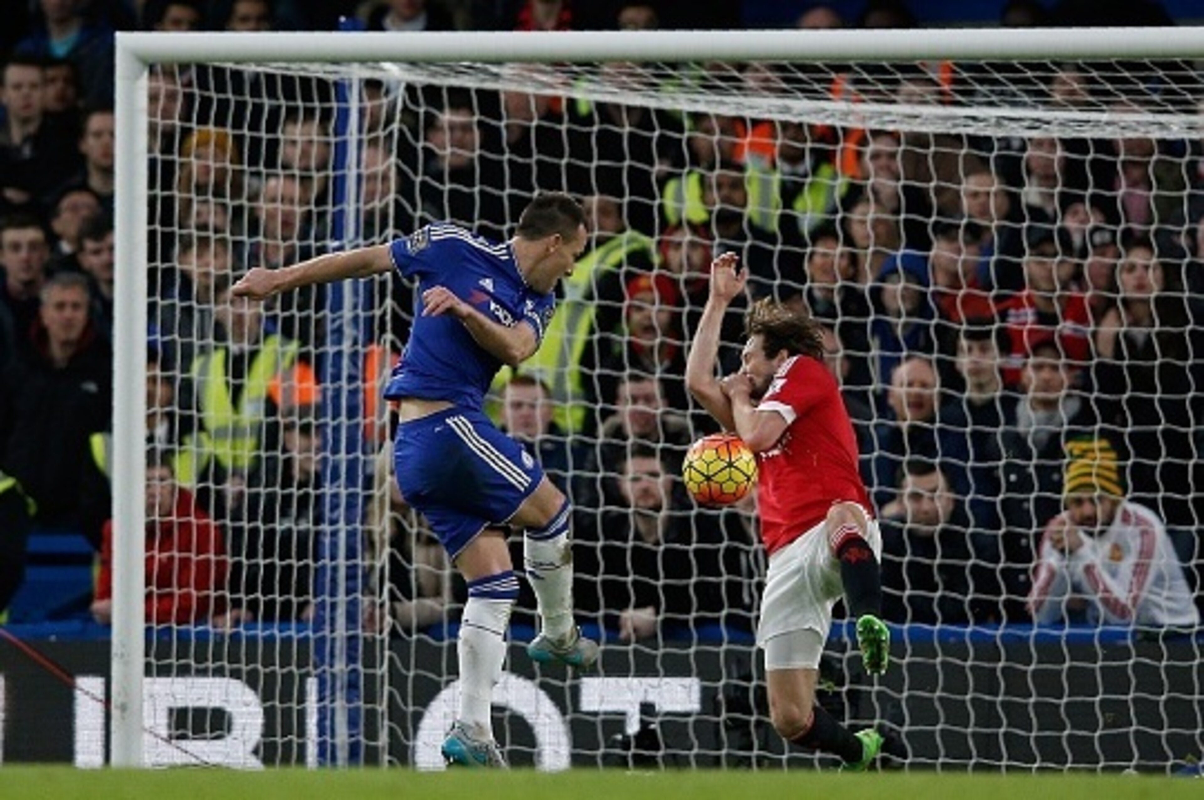 Chelsea's English defender John Terry (L) has a shot on goal blocked by Manchester United's Dutch midfielder Daley Blind during the English Premier League football match between Chelsea and Manchester United at Stamford Bridge in London on February 7, 201
