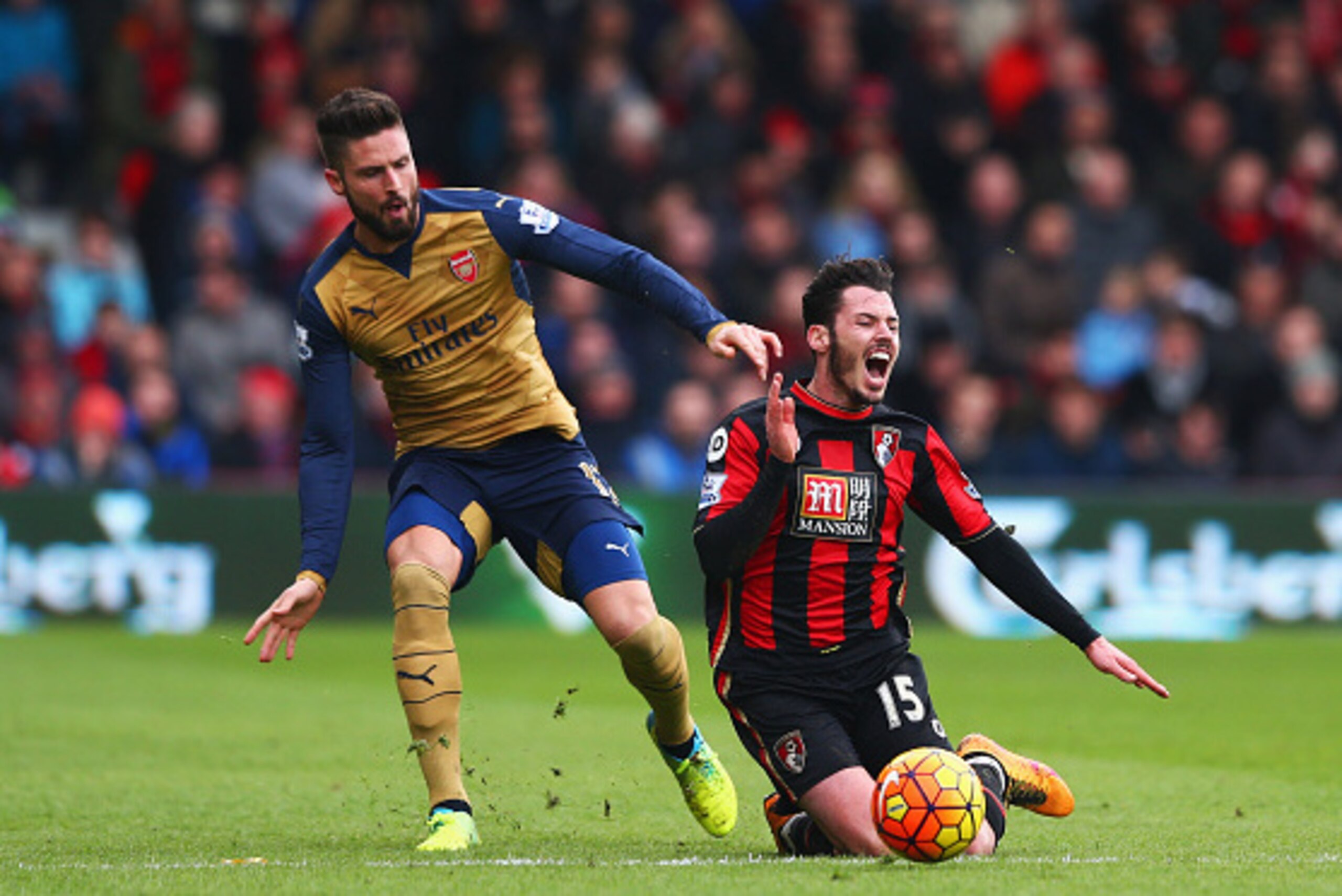 BOURNEMOUTH, ENGLAND - FEBRUARY 07:  Adam Smith of Bournemouth is challenged by Olivier Giroud of Arsenal during the Barclays Premier League match between A.F.C. Bournemouth and Arsenal at the Vitality Stadium on February 7, 2016 in Bournemouth, England. 