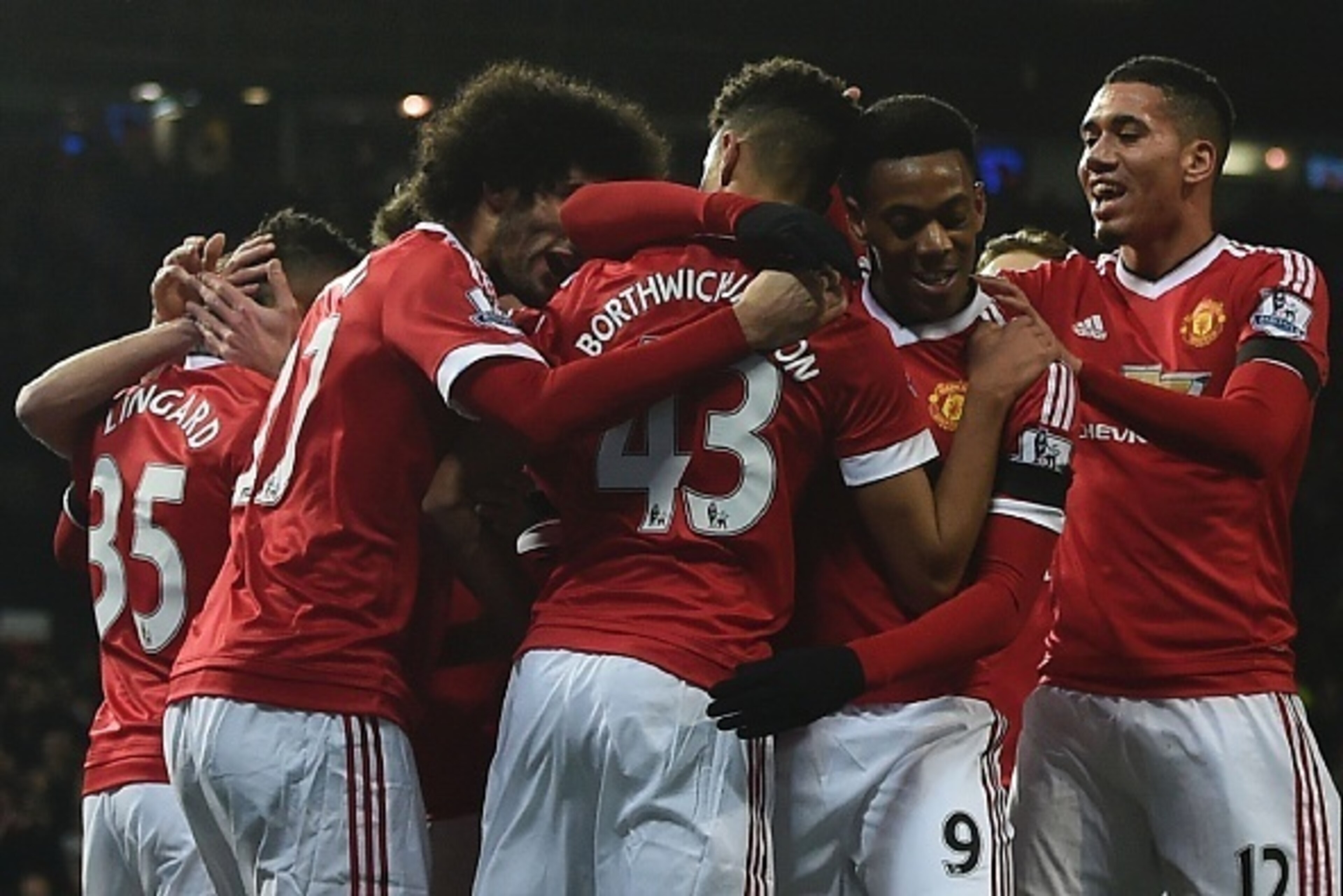 Manchester United players celebrate the opening goal scored by Manchester United's English midfielder Jesse Lingard during the English Premier League football match between Manchester United and Stoke City at Old Trafford in Manchester, north west England