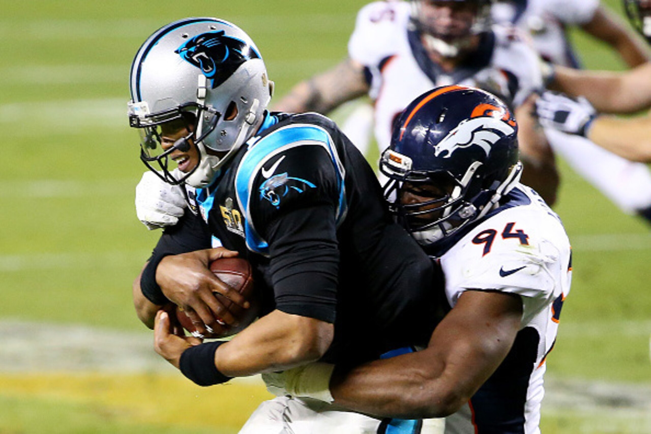 SANTA CLARA, CA - FEBRUARY 07:  Cam Newton #1 of the Carolina Panthers is tackled by  DeMarcus Ware #94 of the Denver Broncos in the fourth quarter during Super Bowl 50 at Levi's Stadium on February 7, 2016 in Santa Clara, California.  (Photo by Maddie Me