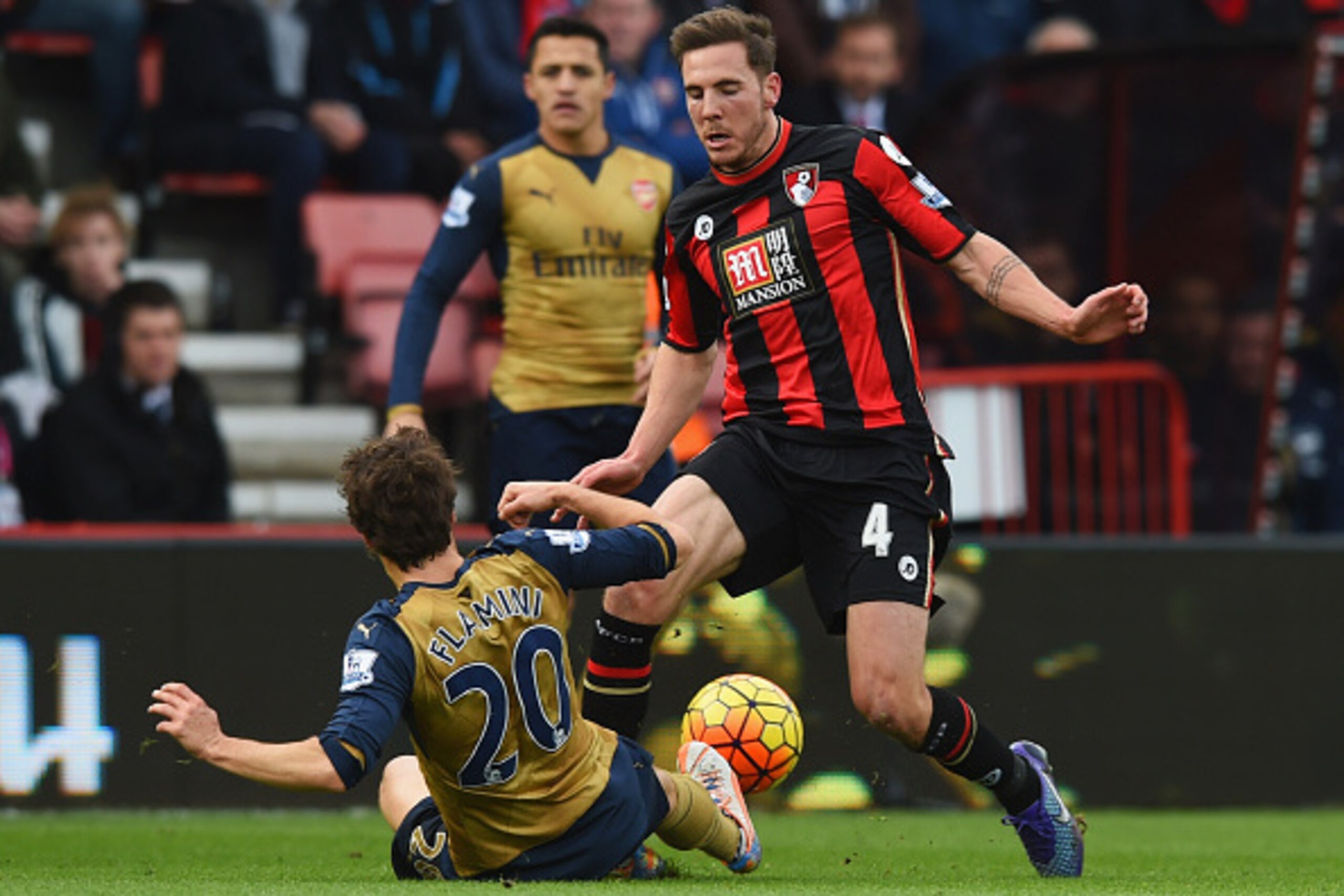 BOURNEMOUTH, ENGLAND - FEBRUARY 07:  Mathieu Flamini of Arsenal slides to challenge Dan Gosling of Bournemouth during the Barclays Premier League match between A.F.C. Bournemouth and Arsenal at the Vitality Stadium on February 7, 2016 in Bournemouth, Engl