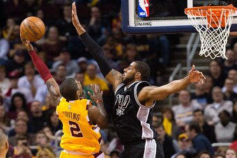 CLEVELAND, OH - JANUARY 30: Kyrie Irving #2 of the Cleveland Cavaliers shoots over LaMarcus Aldridge #12 of the San Antonio Spurs during the second half at Quicken Loans Arena on January 30, 2016 in Cleveland, Ohio. The Cavaliers defeated the Spurs 117-10
