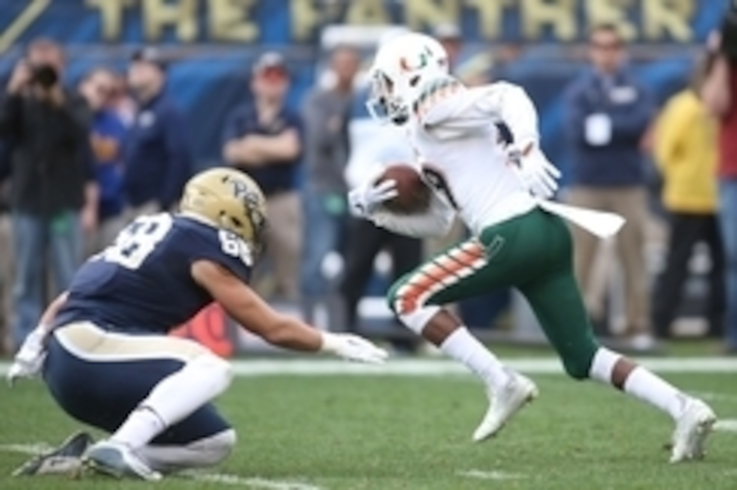 Nov 27, 2015; Pittsburgh, PA, USA; Miami Hurricanes defensive back Corn Elder (29) returns a kick-off against Pittsburgh Panthers linebacker Quintin Wirginis (58) during the second quarter at Heinz Field. Miami won 29-24. Mandatory Credit: Charles LeClair