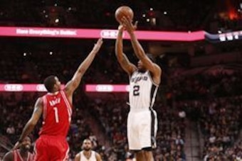 Jan 27, 2016; San Antonio, TX, USA; San Antonio Spurs small forward Kawhi Leonard (2) shoots the ball over Houston Rockets small forward Trevor Ariza (1) during the first half at AT&T Center. Mandatory Credit: Soobum Im-USA TODAY Sports